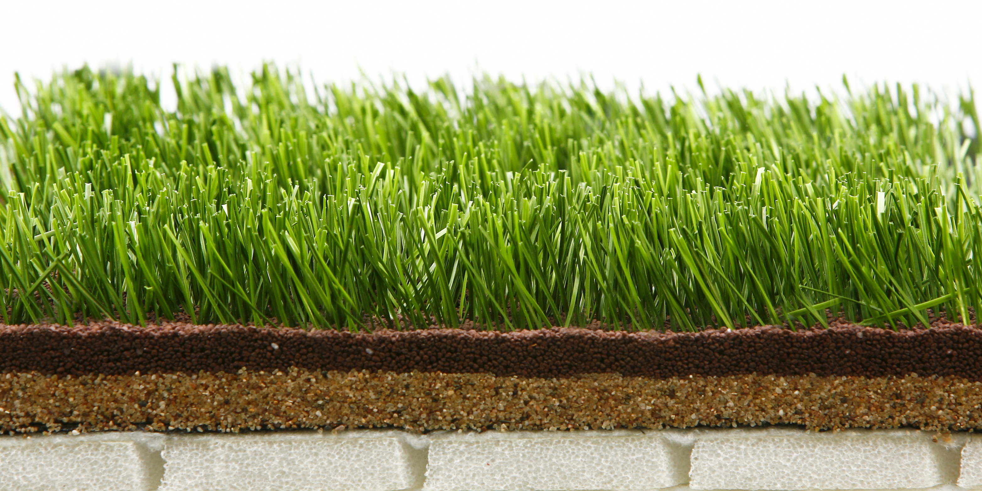 Why spread sand on artificial grass?