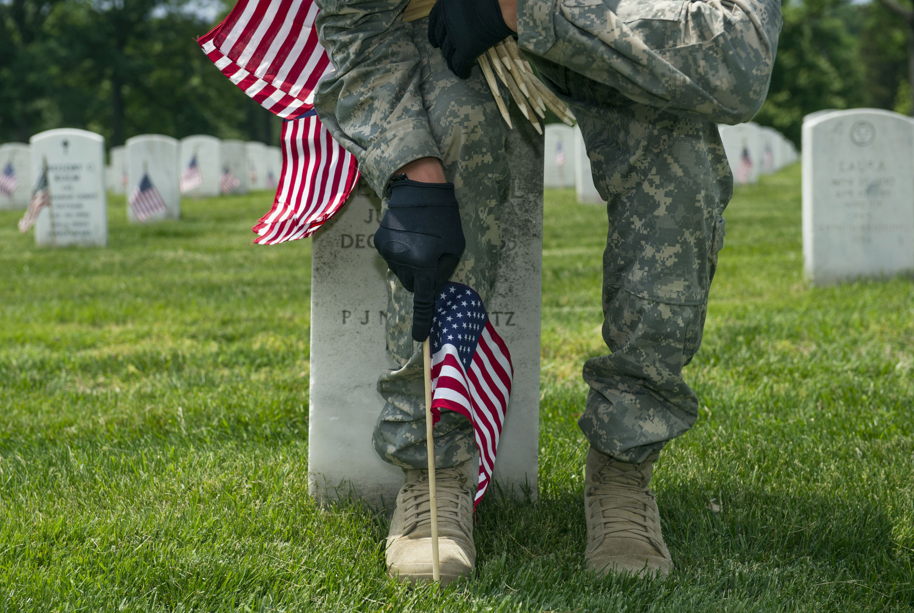 WTOP | Flags being placed on Arlington National Cemetery graves