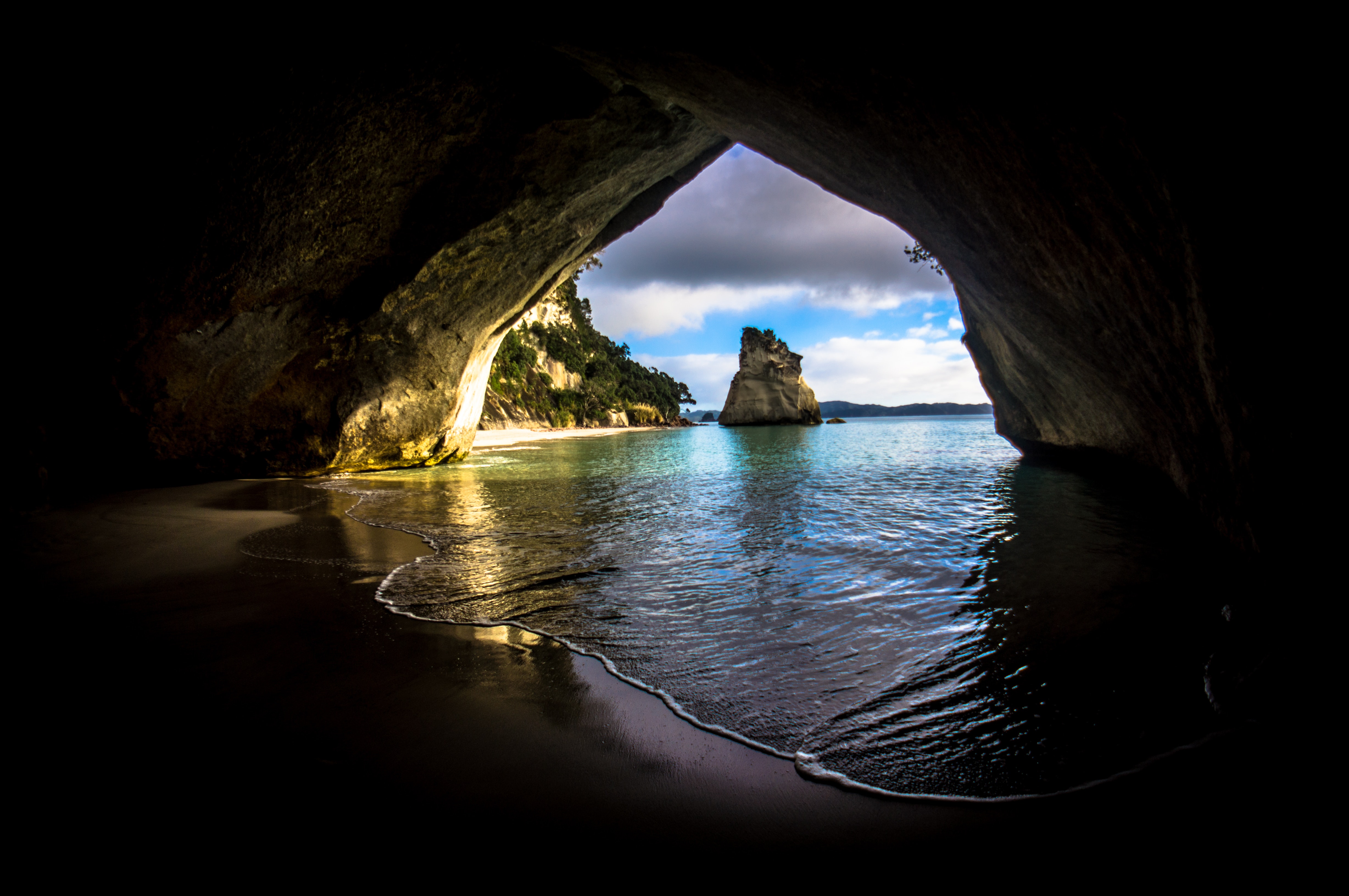 Gray and brown cave near on the ocean photo