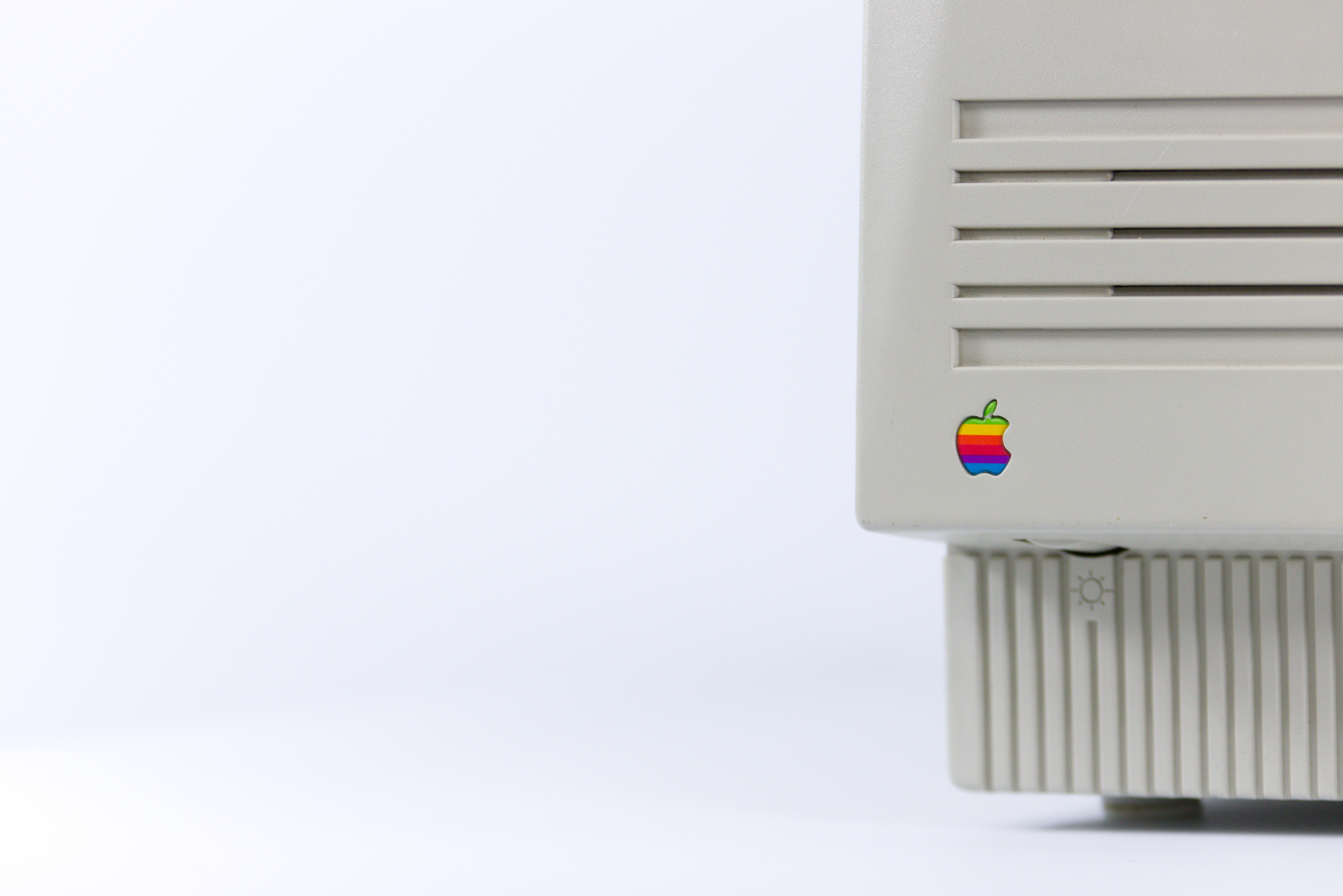 Gray device with apple logo on white surface photo