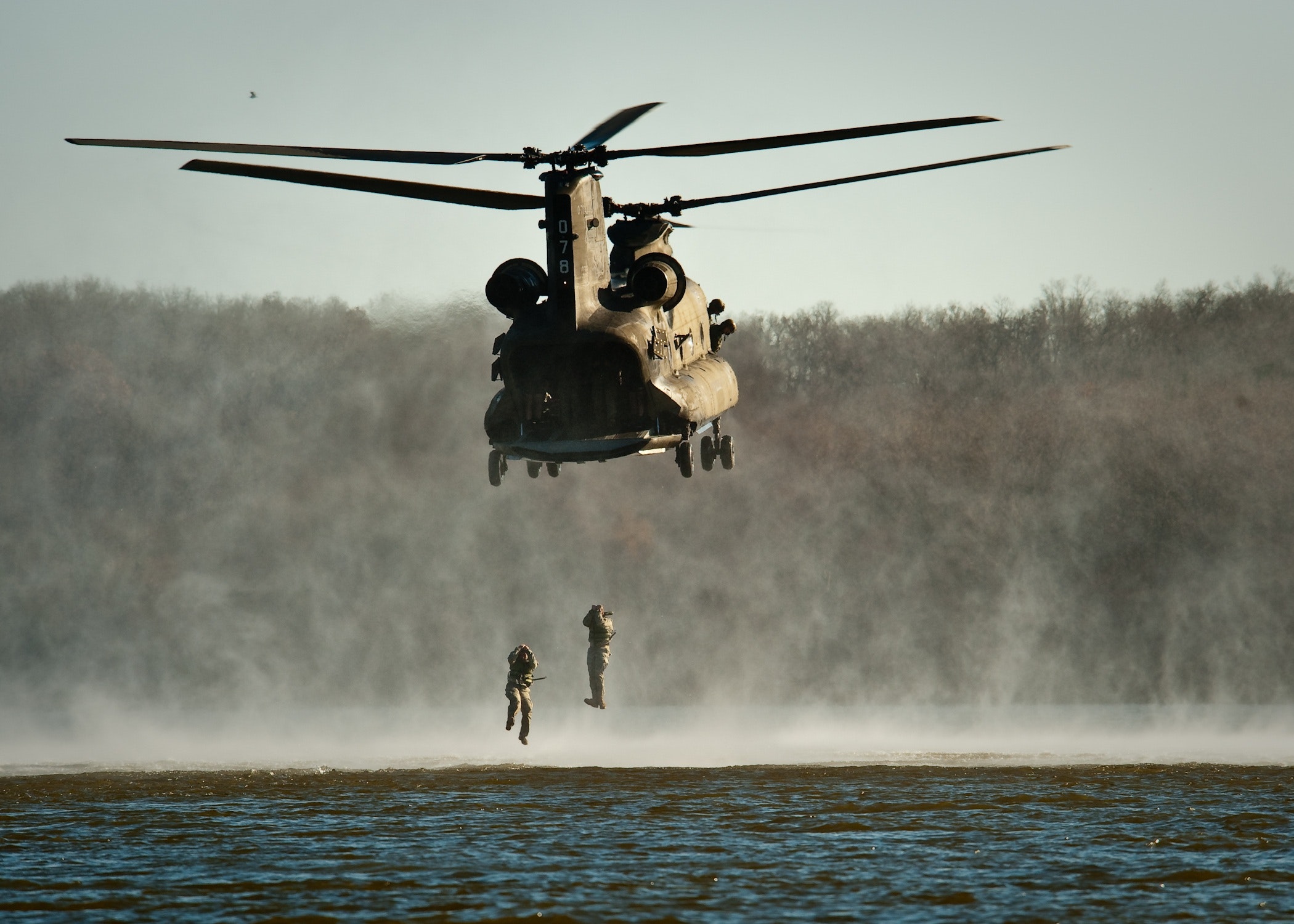 Gray helicopter above body of water photo