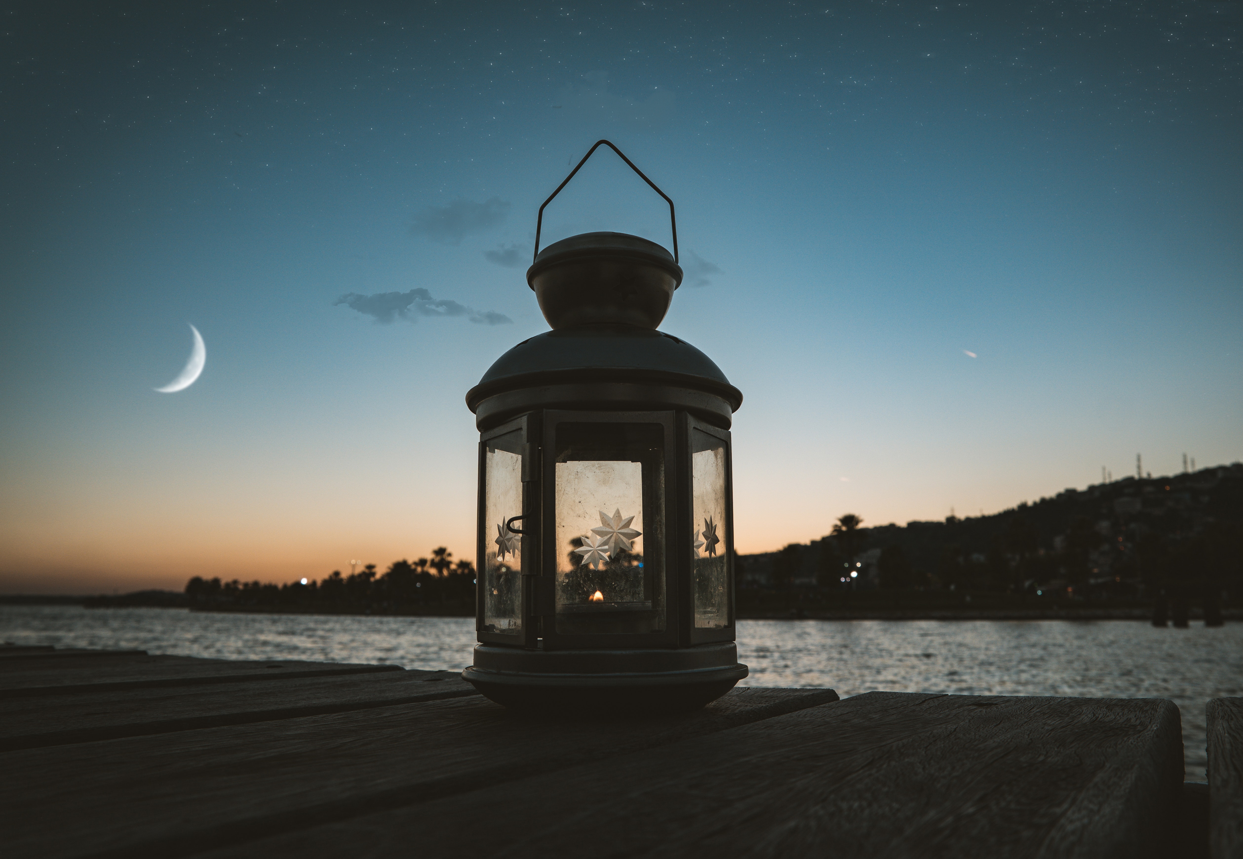 Gray metal candle lantern on boat dock photo