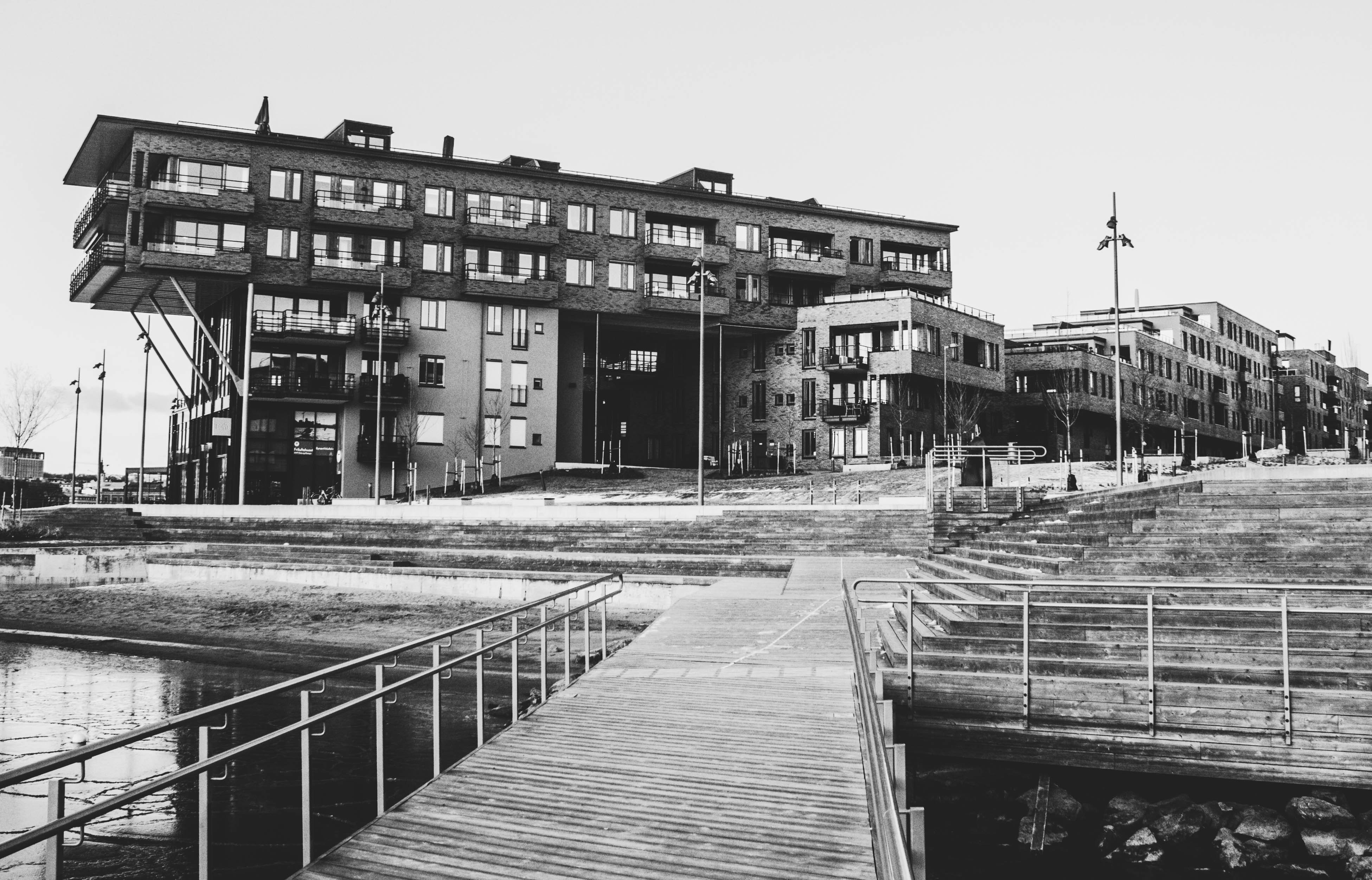 Gray scale photo of a dock near a building