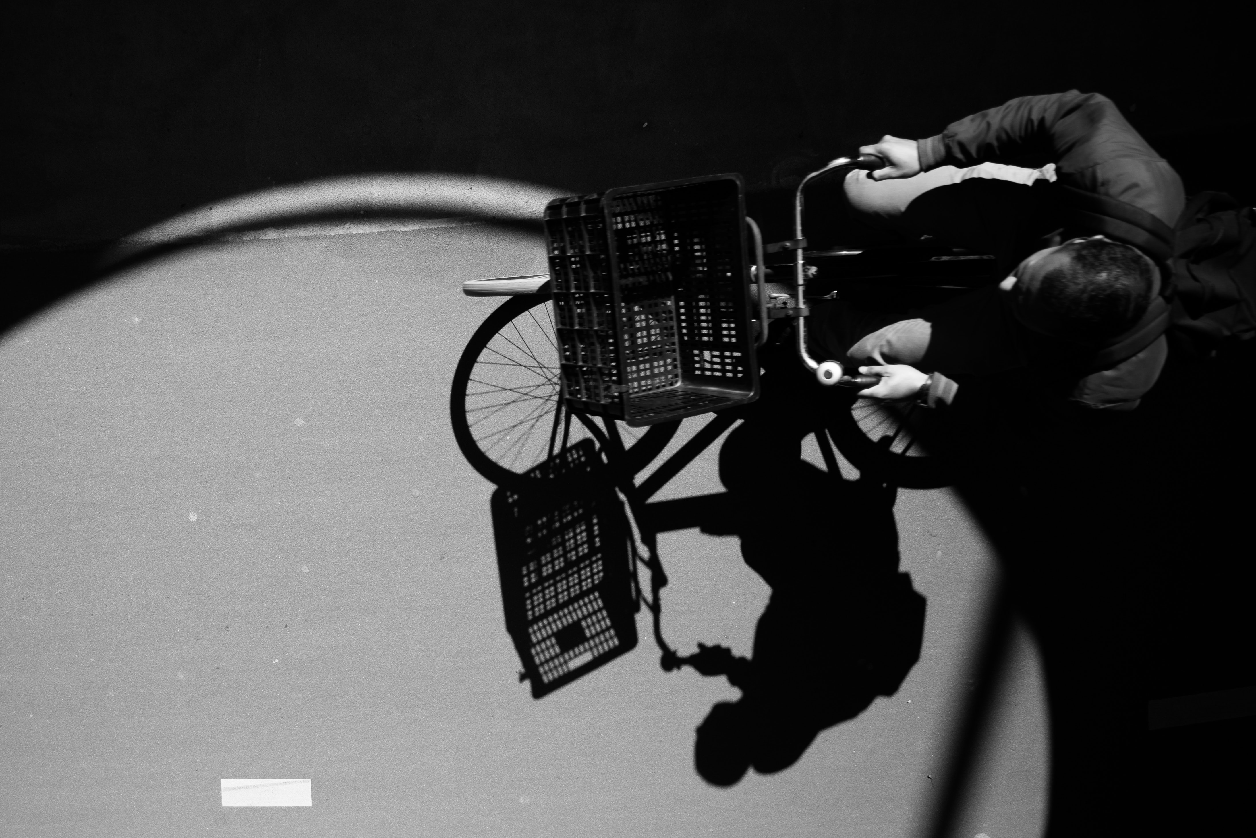Gray scale photo ofman on city bike