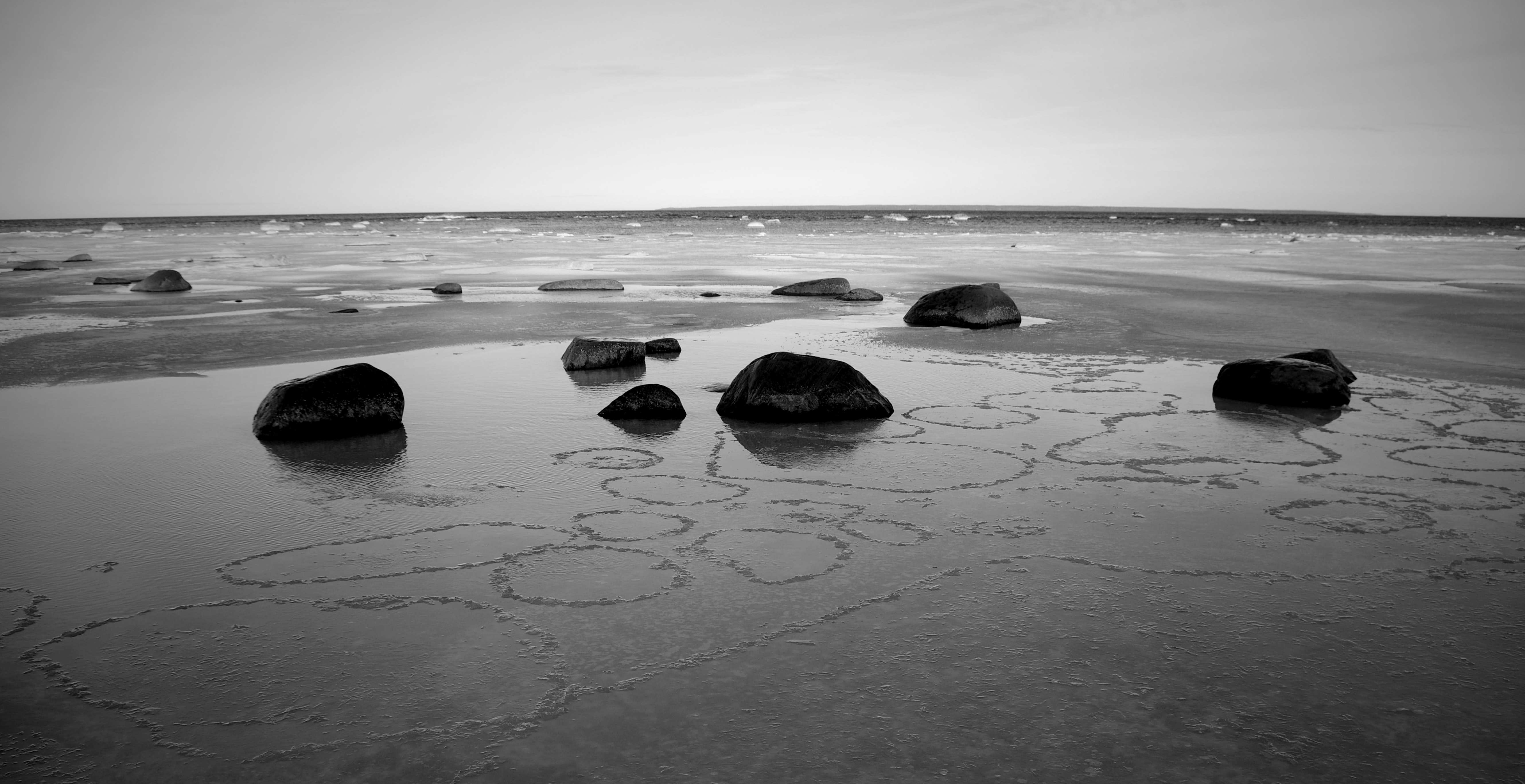 Grayscale concrete stones on sand photo