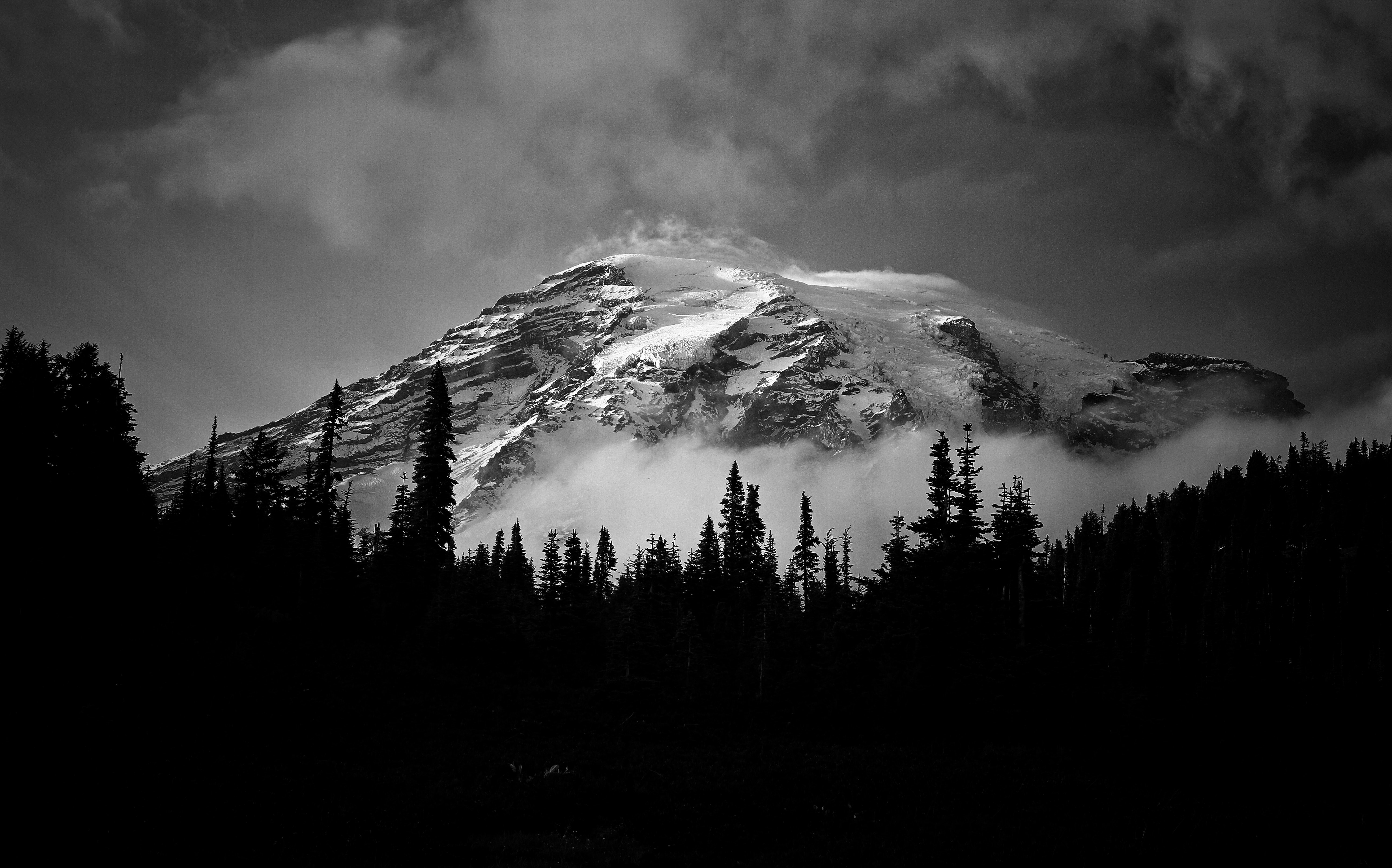 Grayscale photo of a mountain covered with snow
