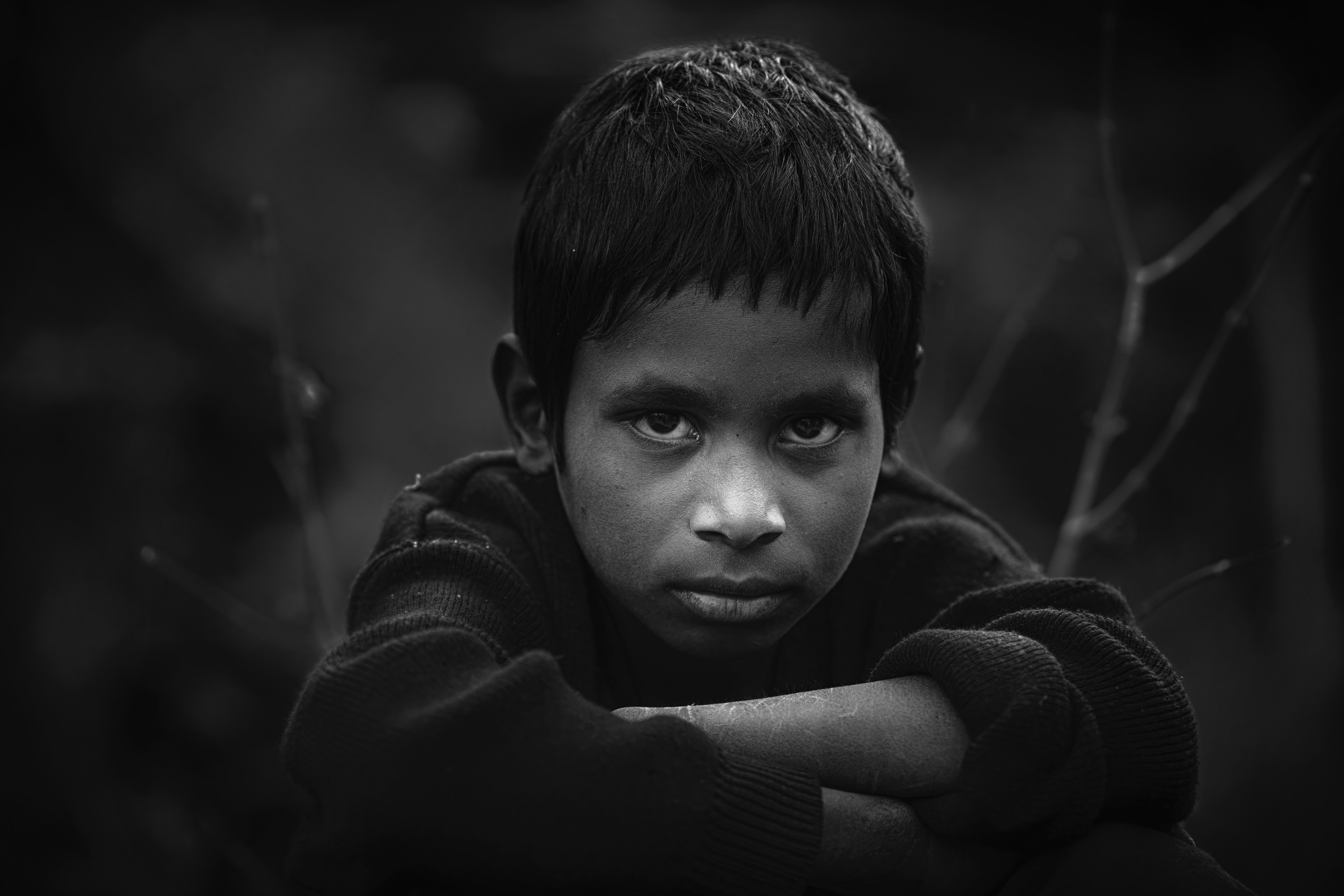 Grayscale photo of boy in long-sleeved shirt