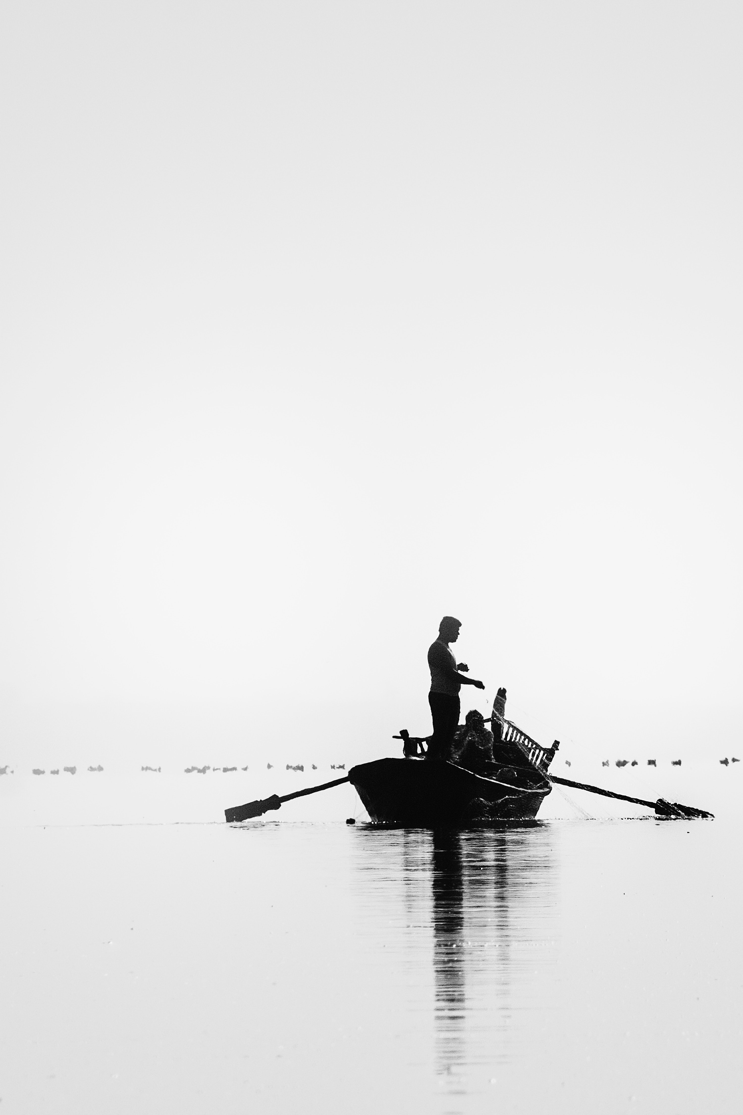 Grayscale picture of two people go on fishing photo