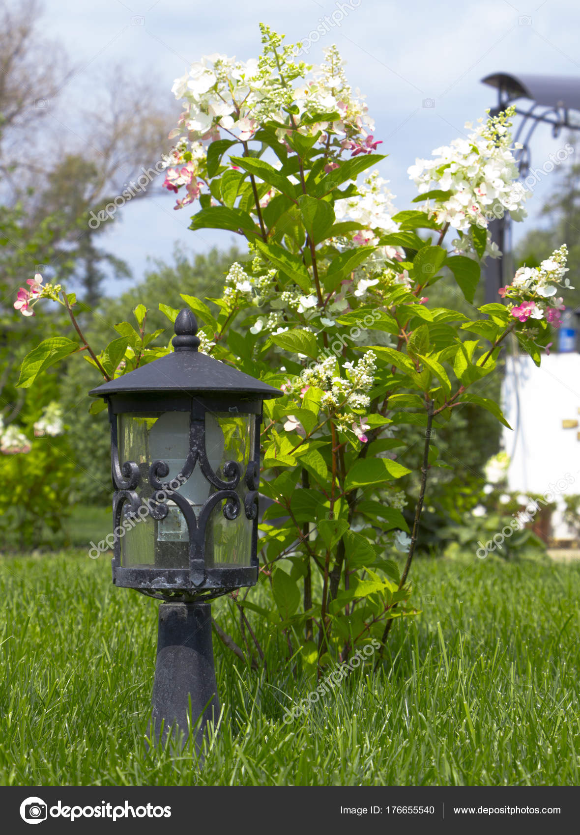 garden lamp, made in the Middle Ages, on a lawn with a juicy green ...