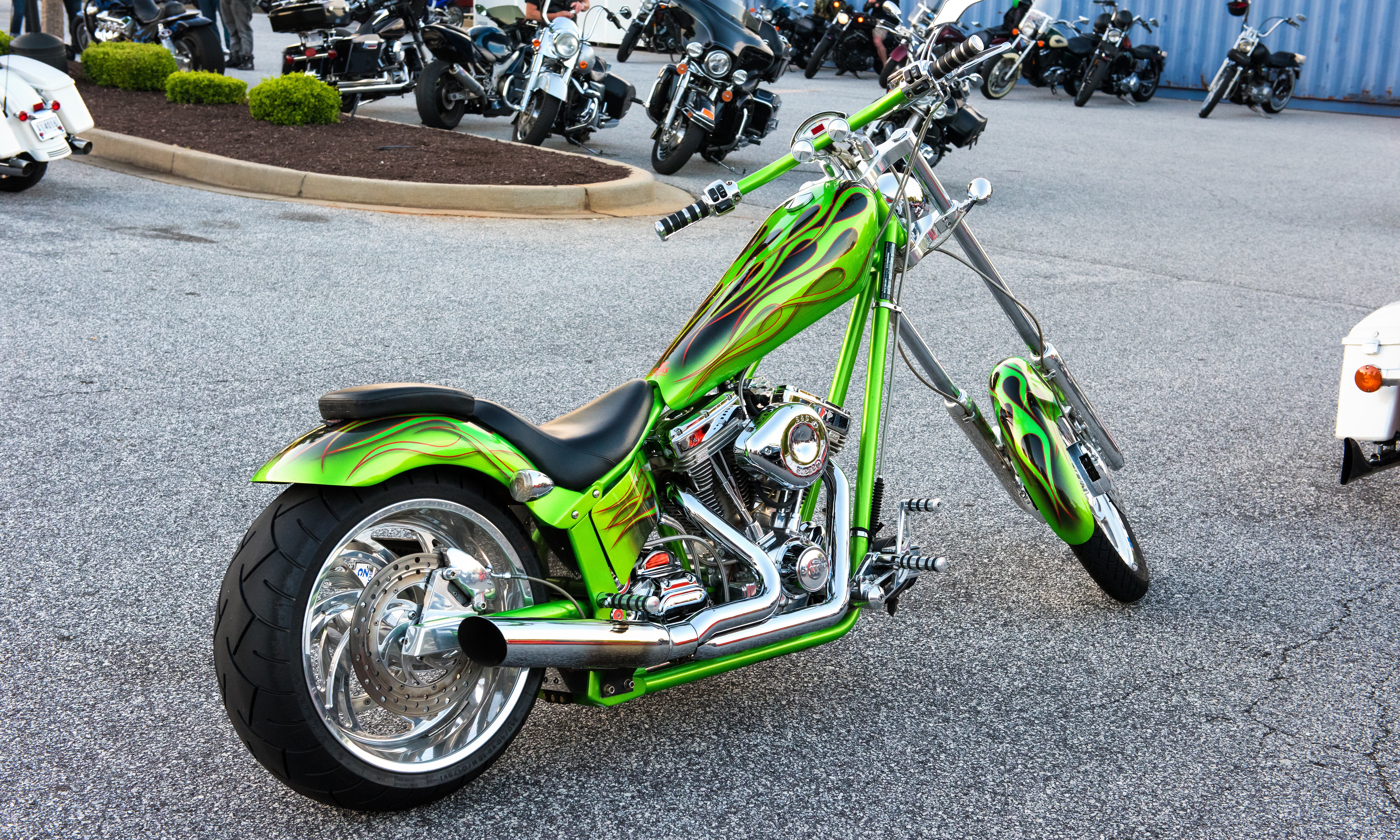 Green naked chopper motorcycle on parking lot photo