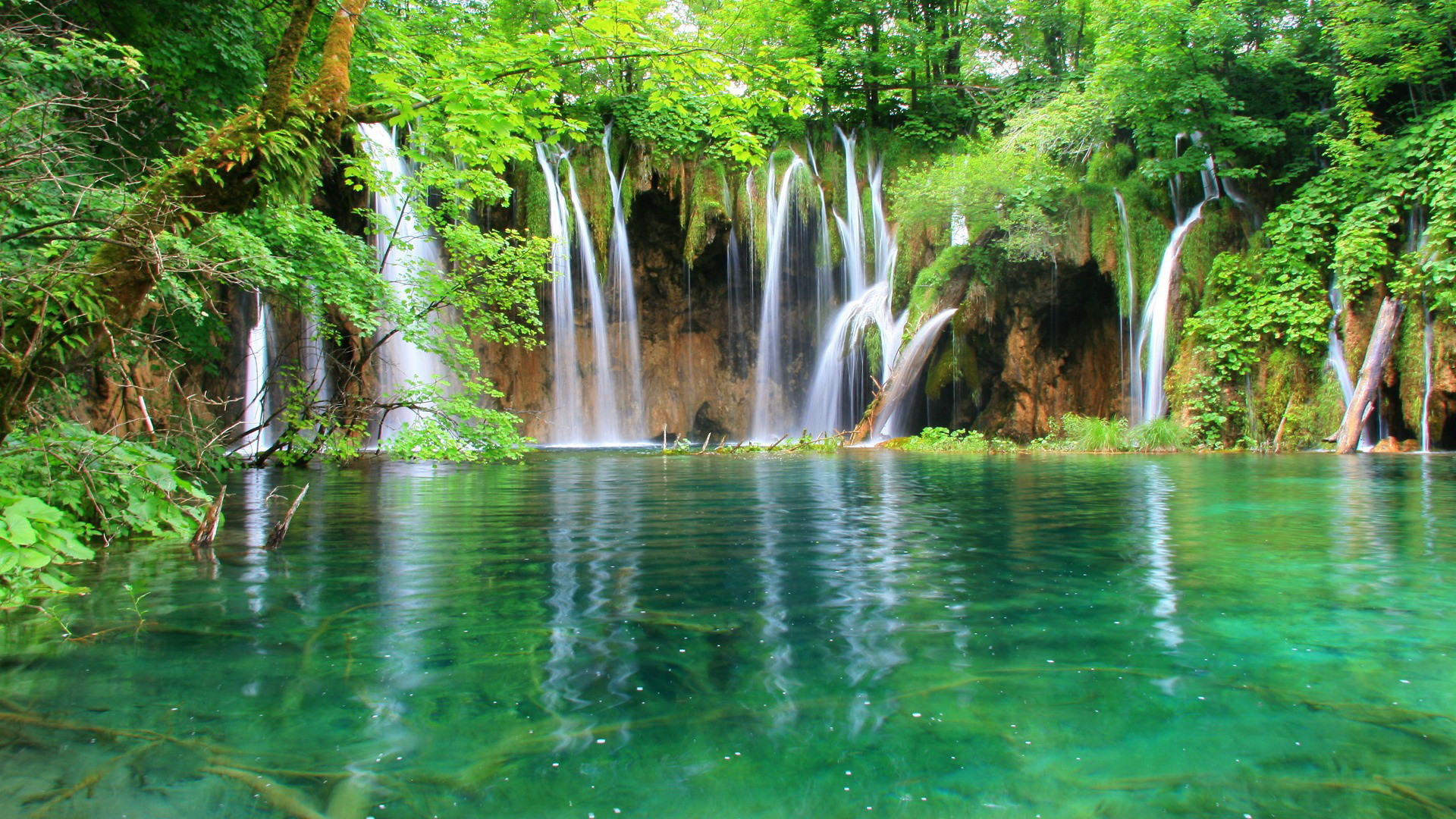 Green nature - beautiful waterfall and mountain lake