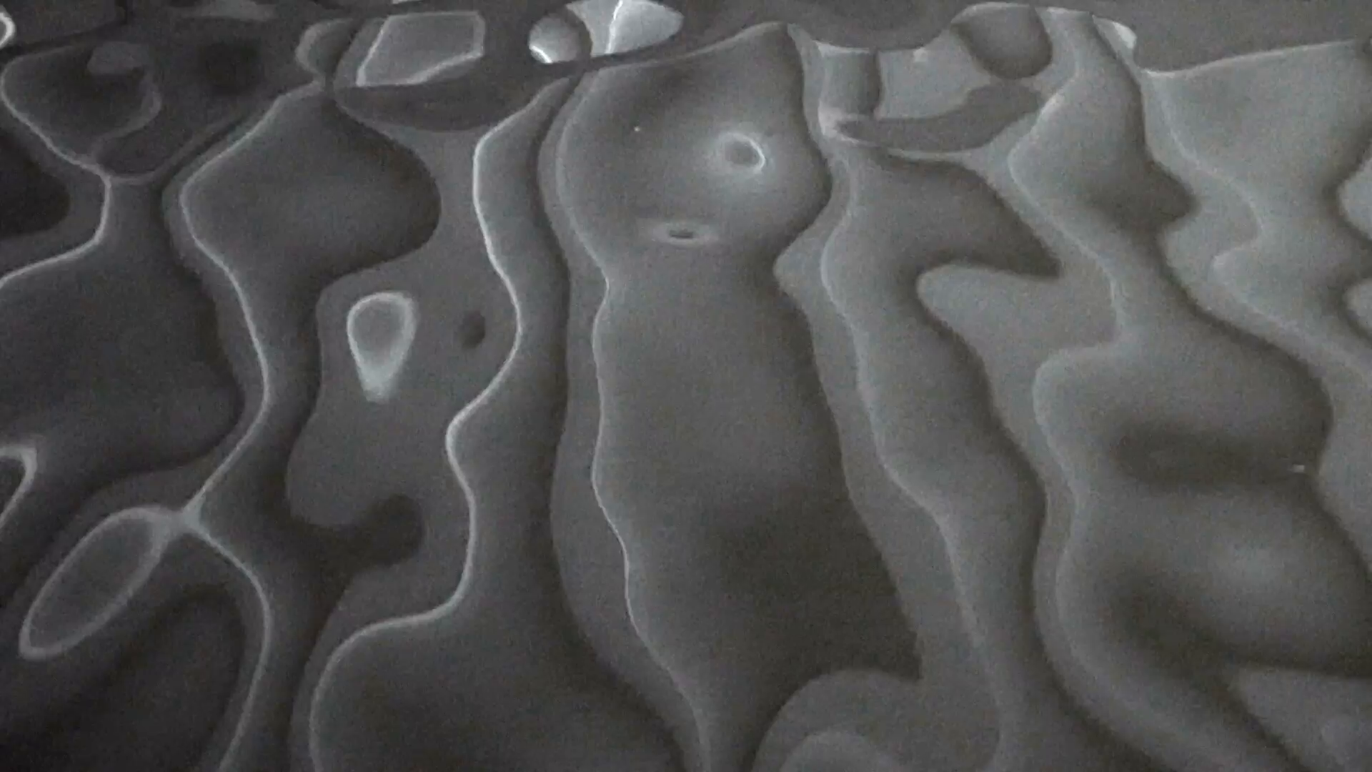 Black, grey and white water ripples creating patterns resembling ...