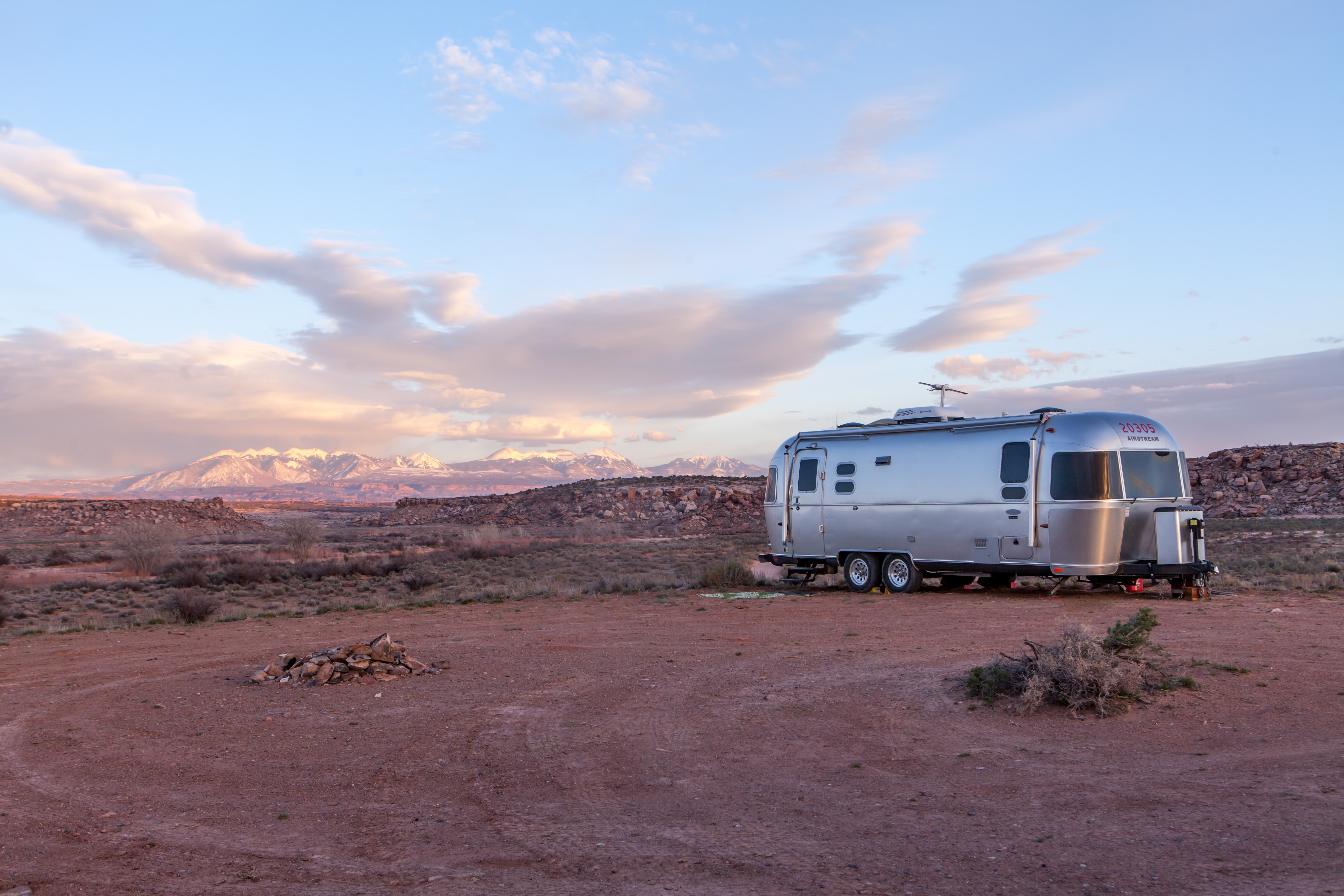 Grey and black recreational vehicle on ground under blue and white sky photo