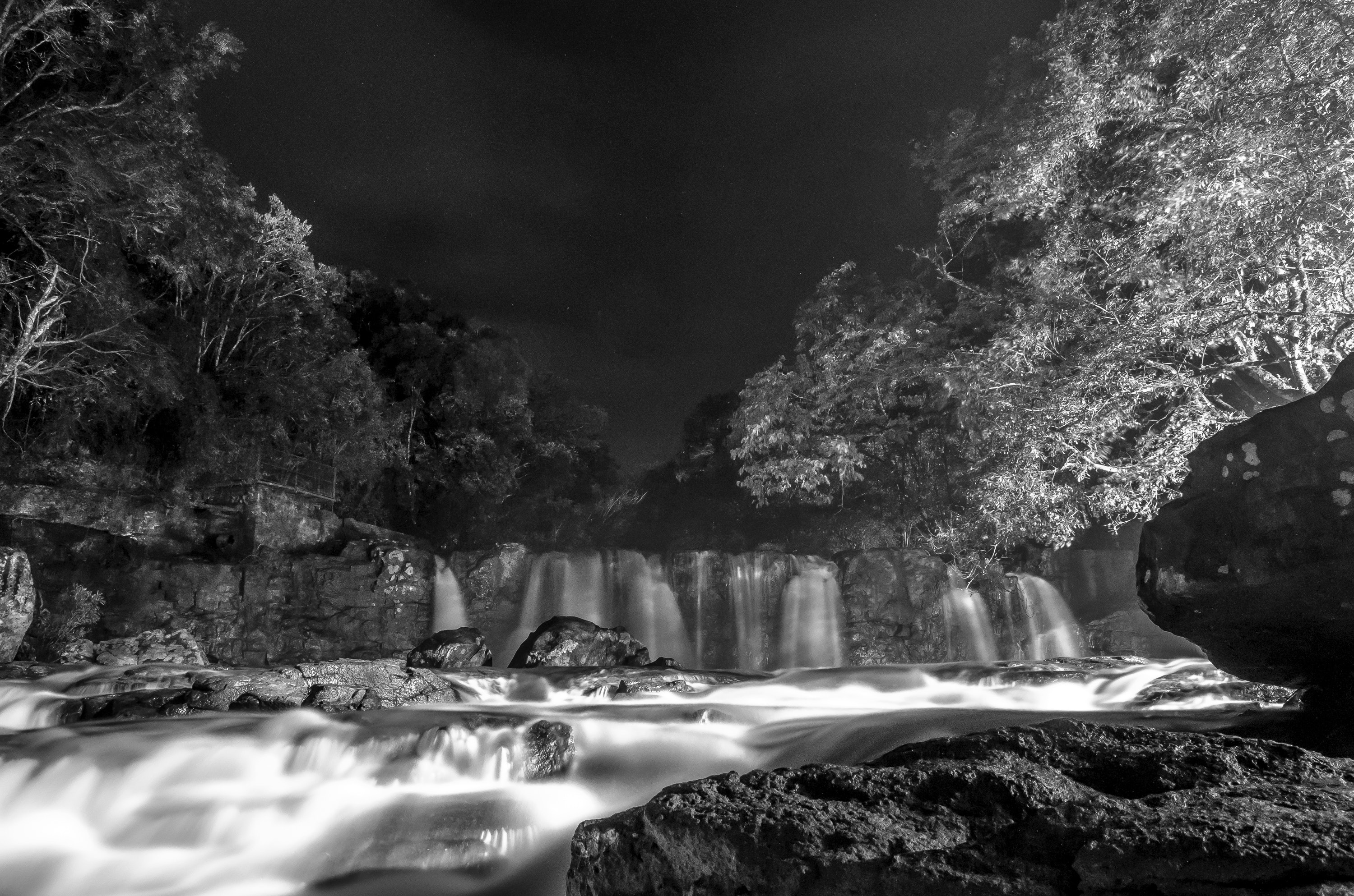 Greyscale photo of waterfall during nighttime