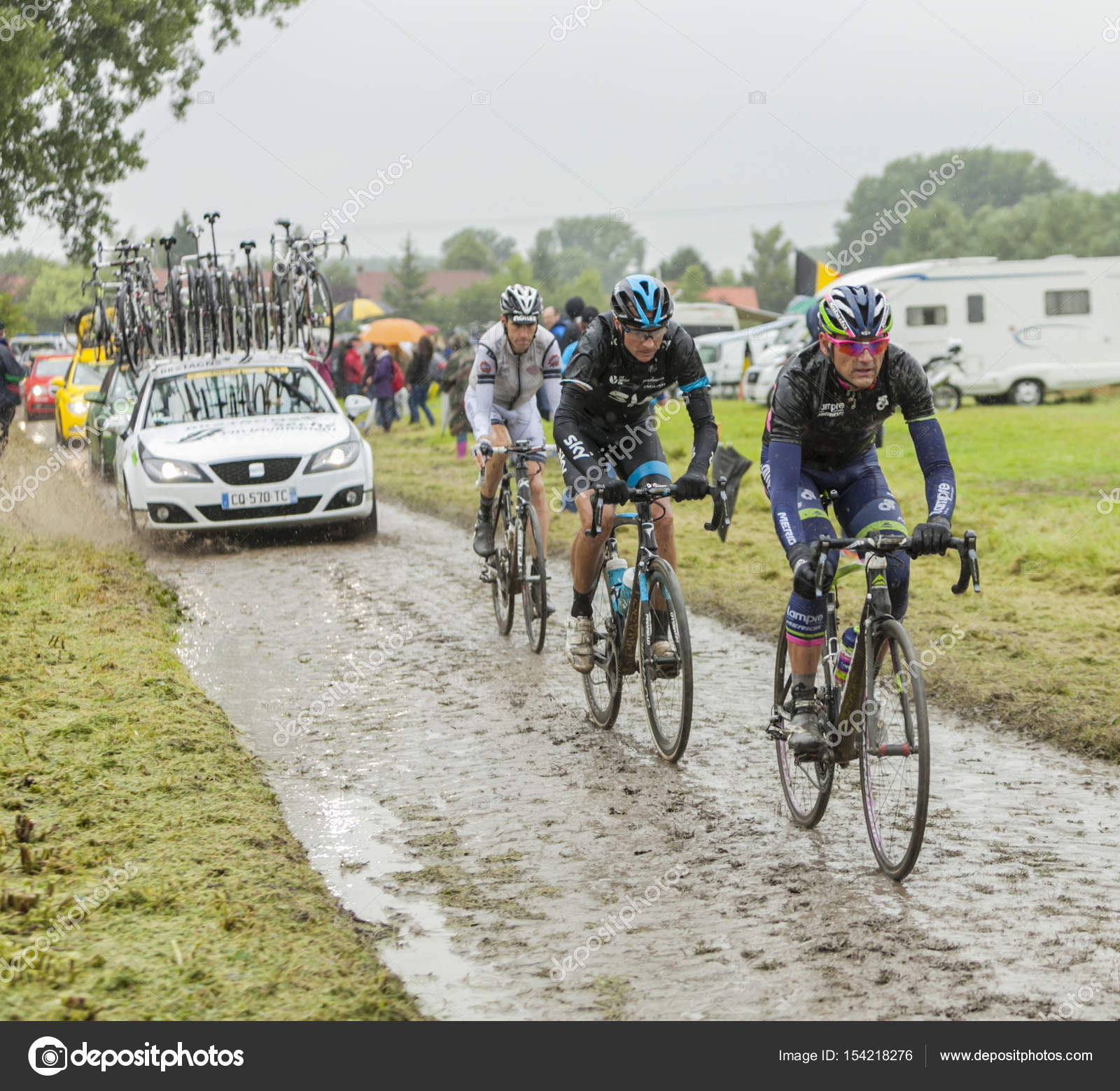 Group of Cyclists on a Cobblestone Road - Tour de France 2014 ...
