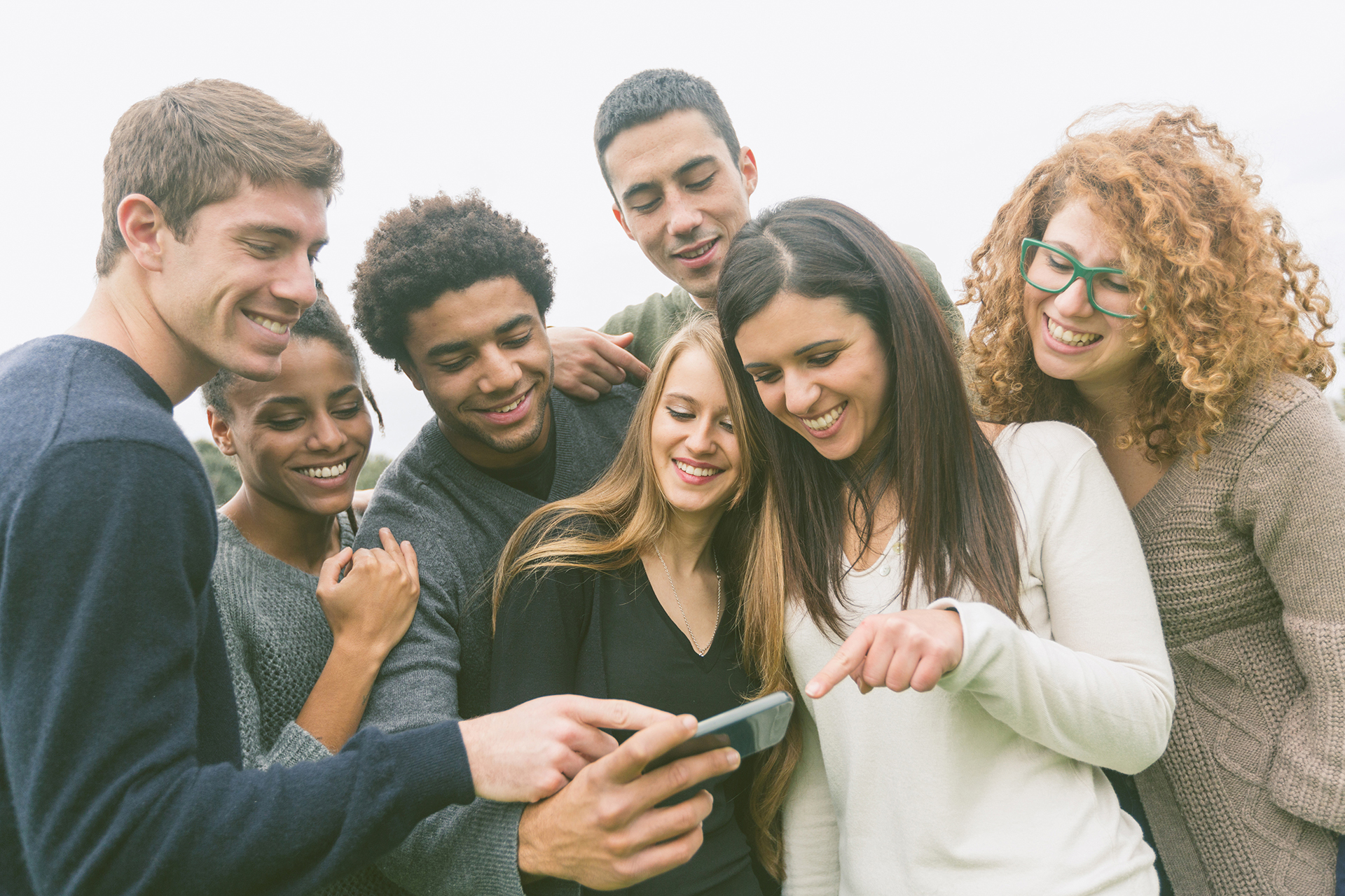 Group of Friends Looking at Phone | Living Word Christian Fellowship