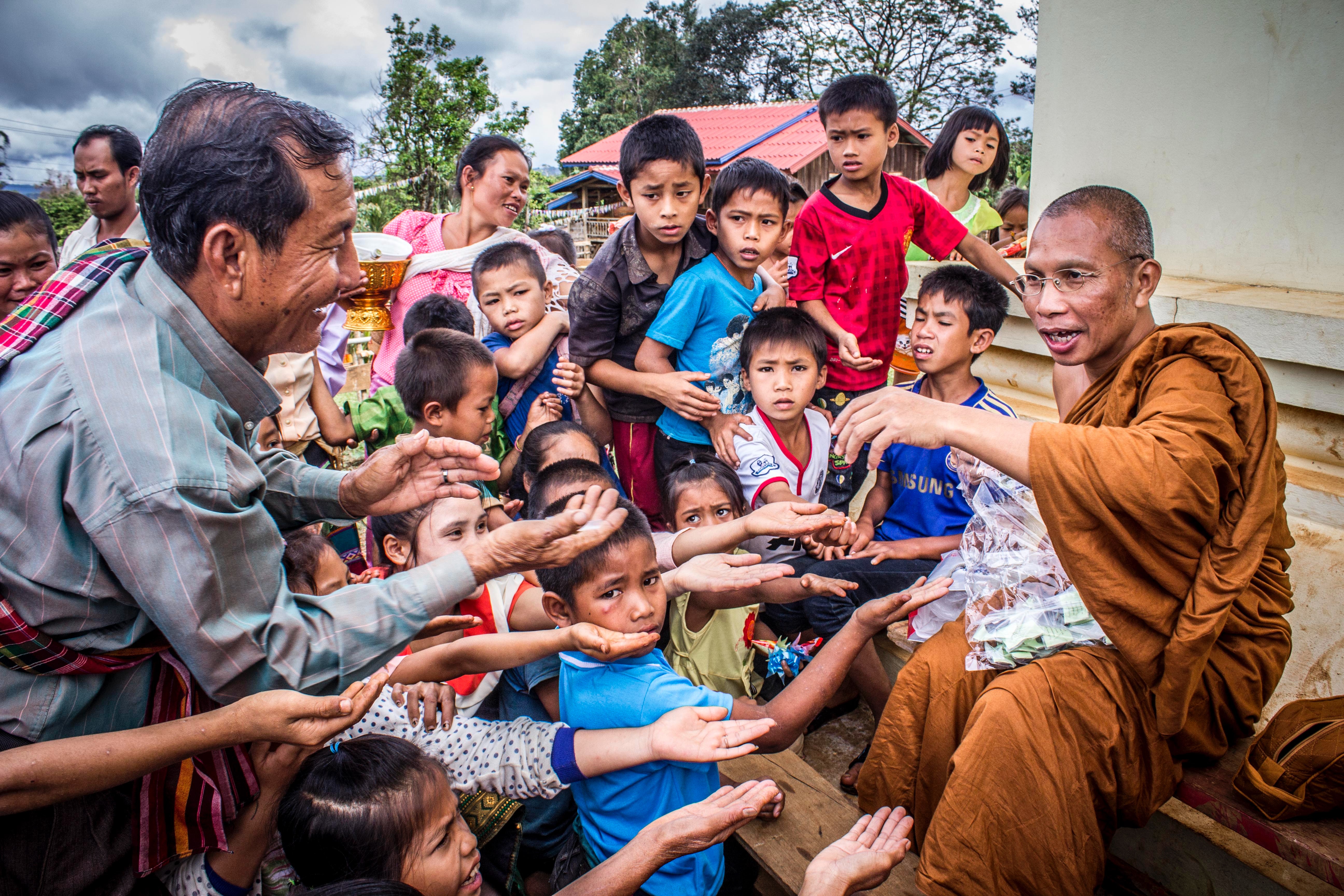 Group of people begging on monk photo