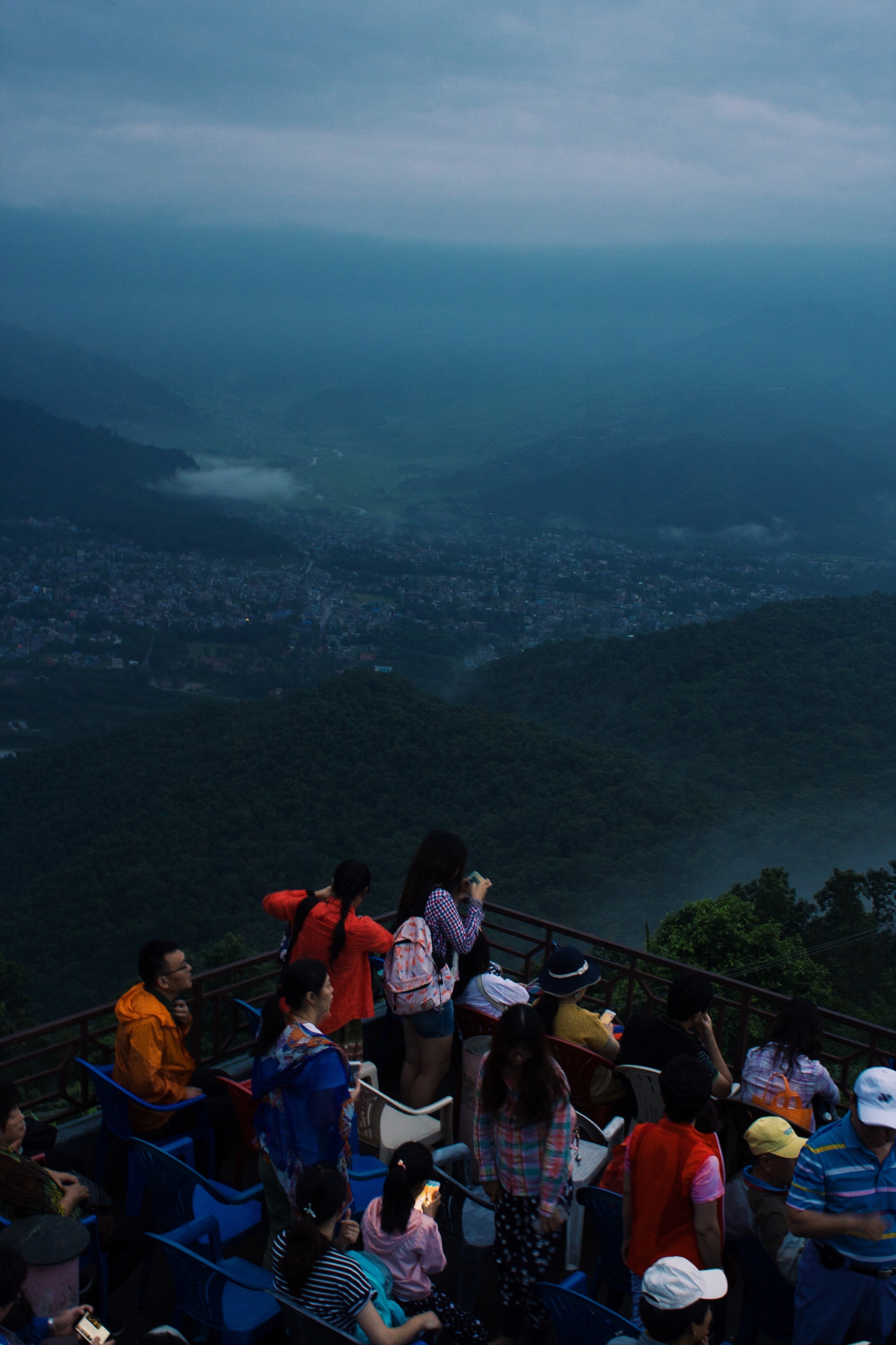 Group of people looking at mountain and city view photo