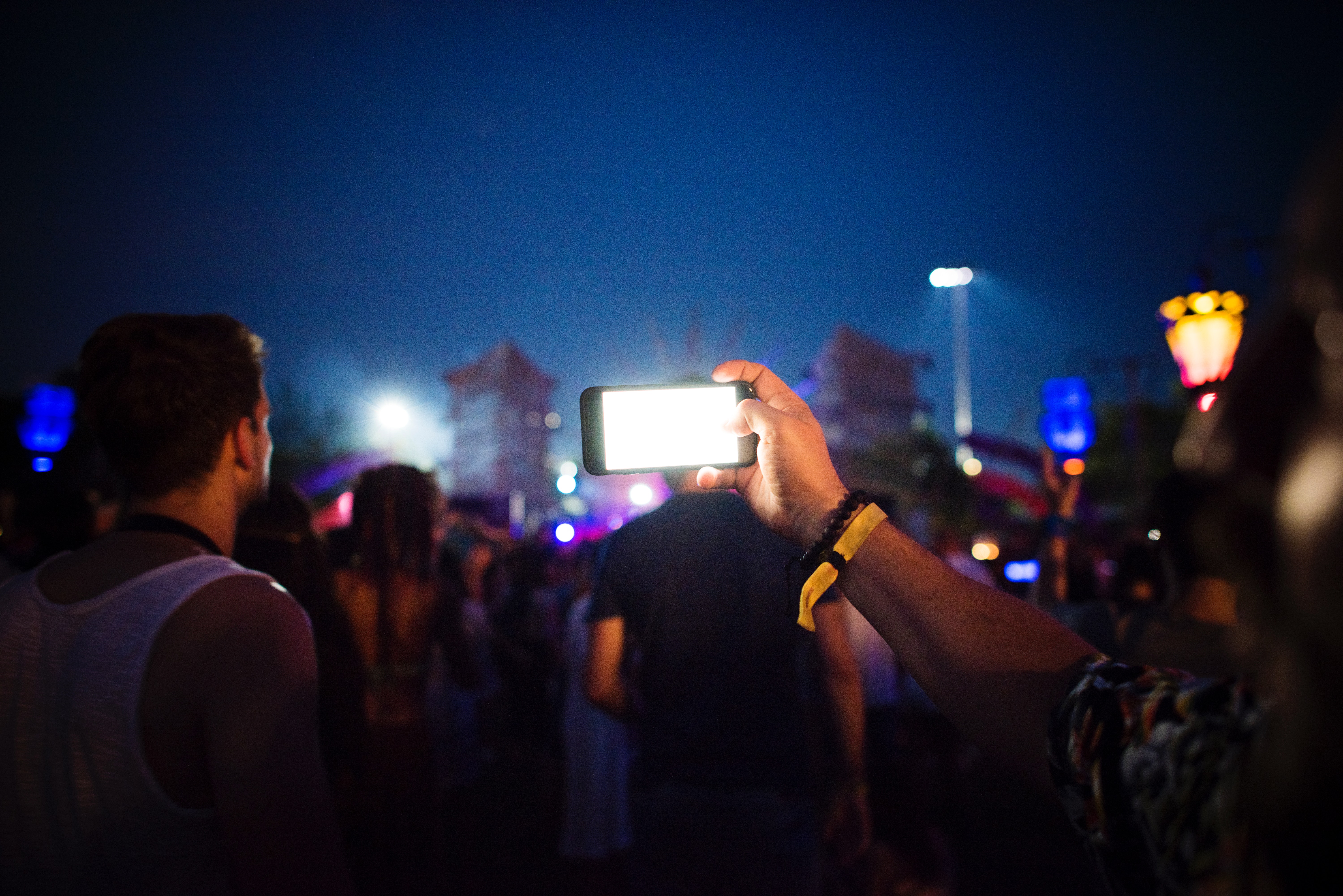 Group of people using smartphones during nighttime photo