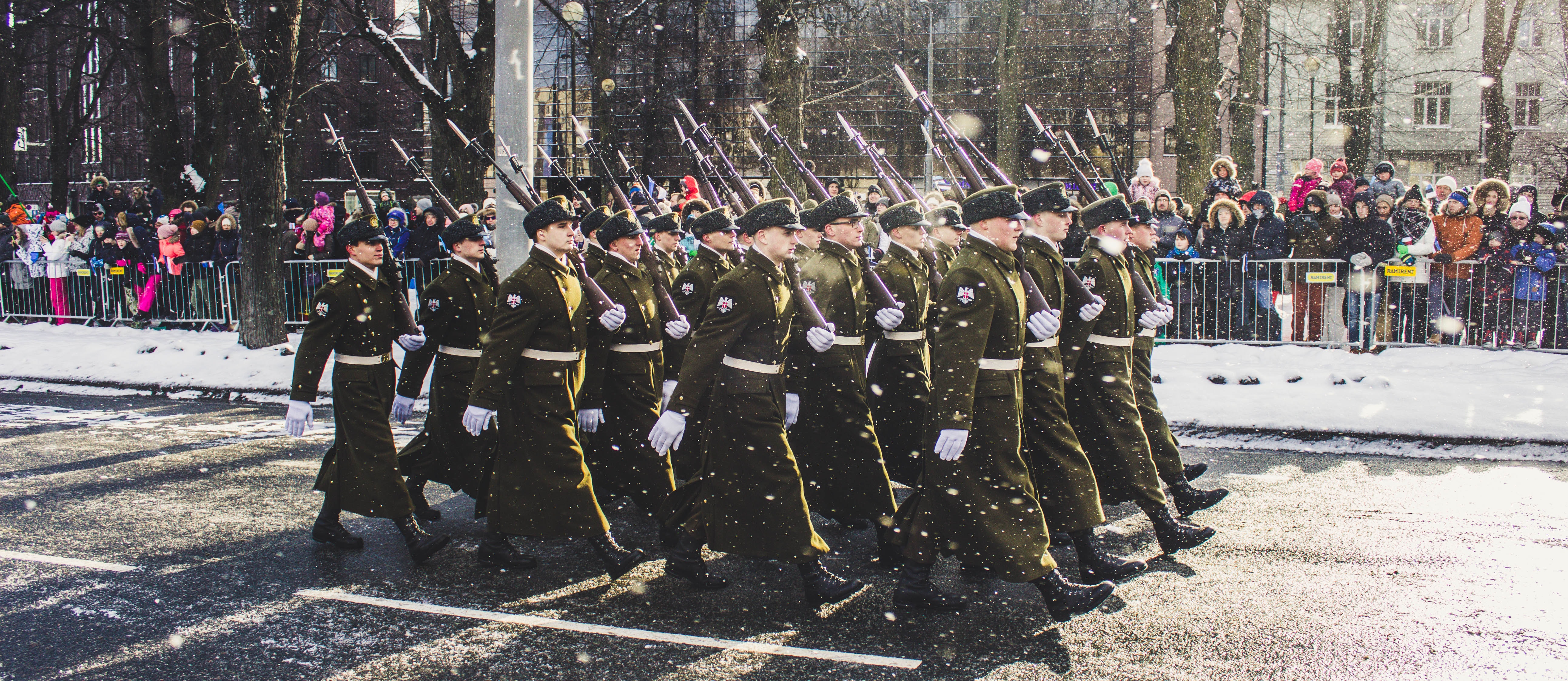 Group of soldiers parading on concrete road photo