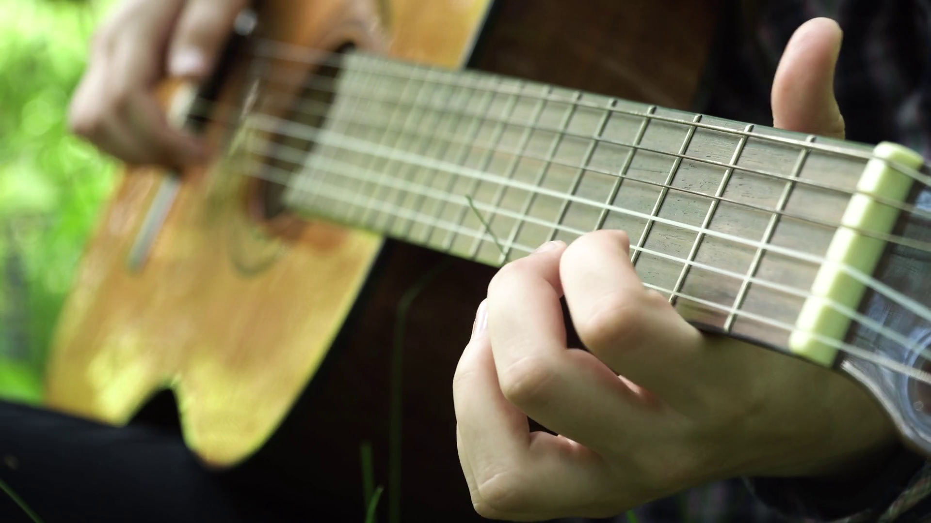 Female hand playing on acoustic guitar. Closeup of young woman's ...