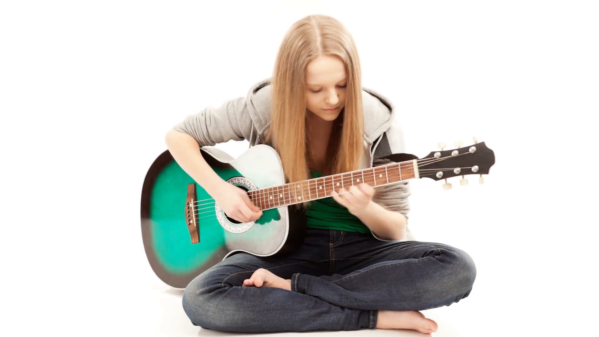 Guitarist, Girl playing a guitar while sitting on the floor ...