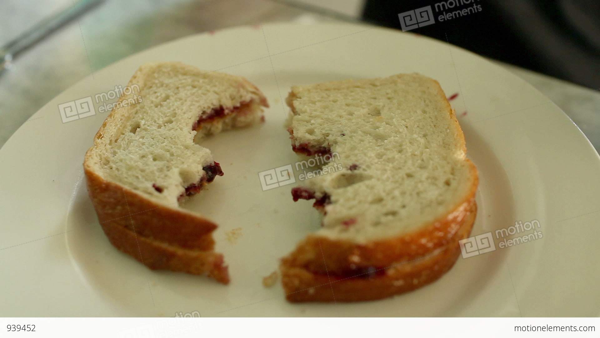 Person Placing Half Eaten Sandwich On Plate Stock video footage | 939452