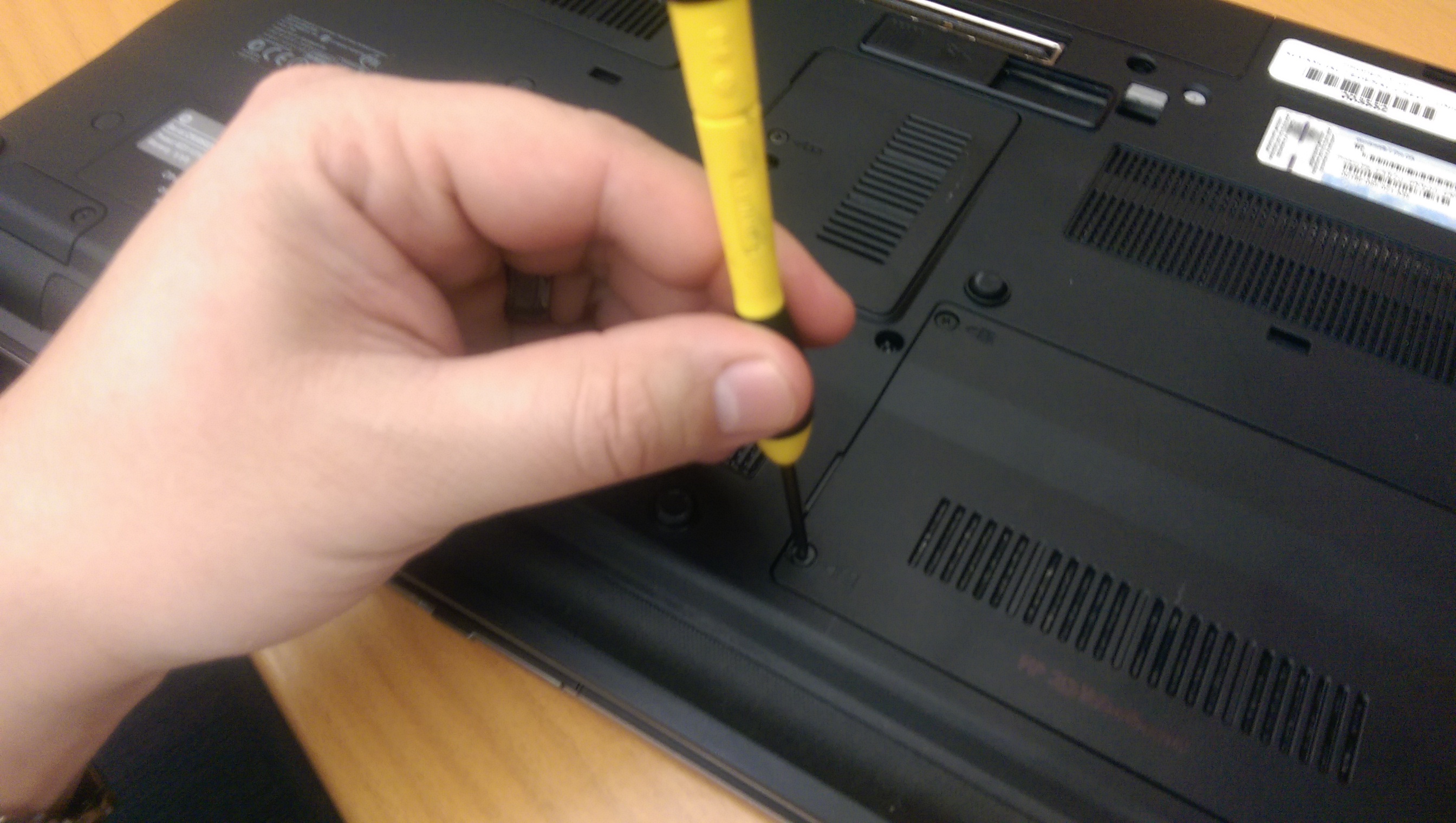 Hand holding a laptop screwdriver photo