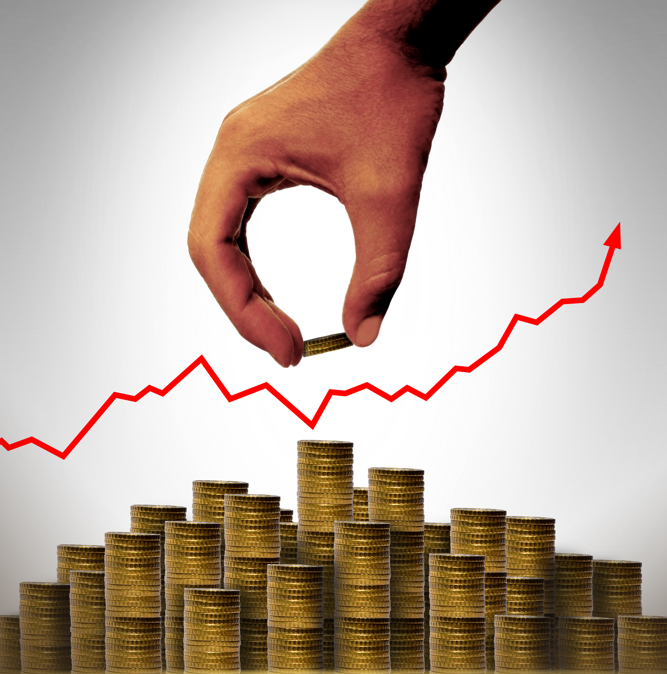 Hand placing coins on a coin stack with upward arrow photo