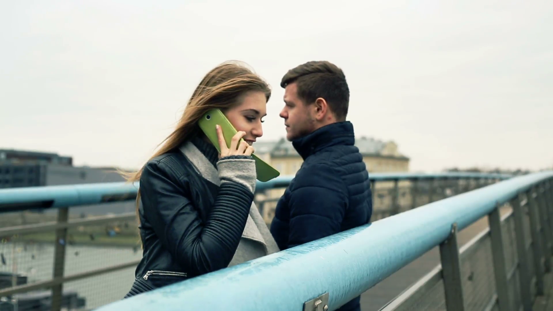 Happy couple talking on cellphone in city on bridge Stock Video ...