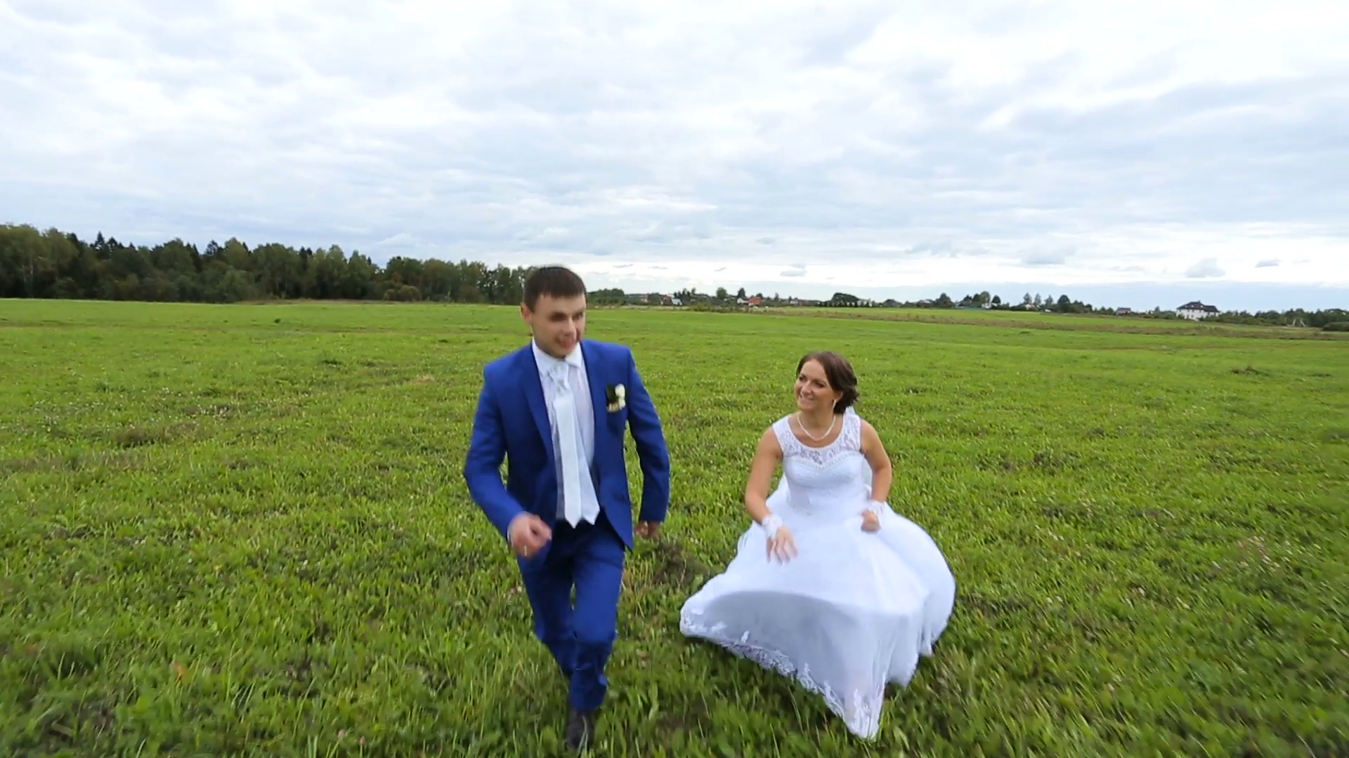 Happy newlyweds,couple running on a green meadow field. Loving ...
