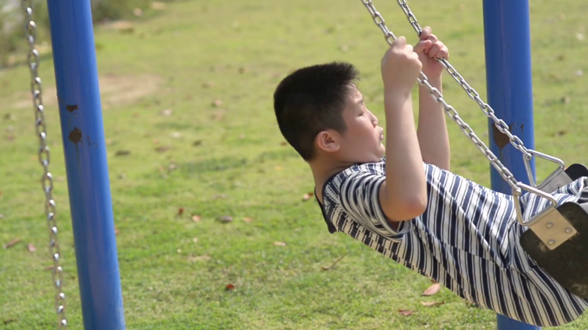 Asian boy playing on a swing and having fun in park Stock Video ...