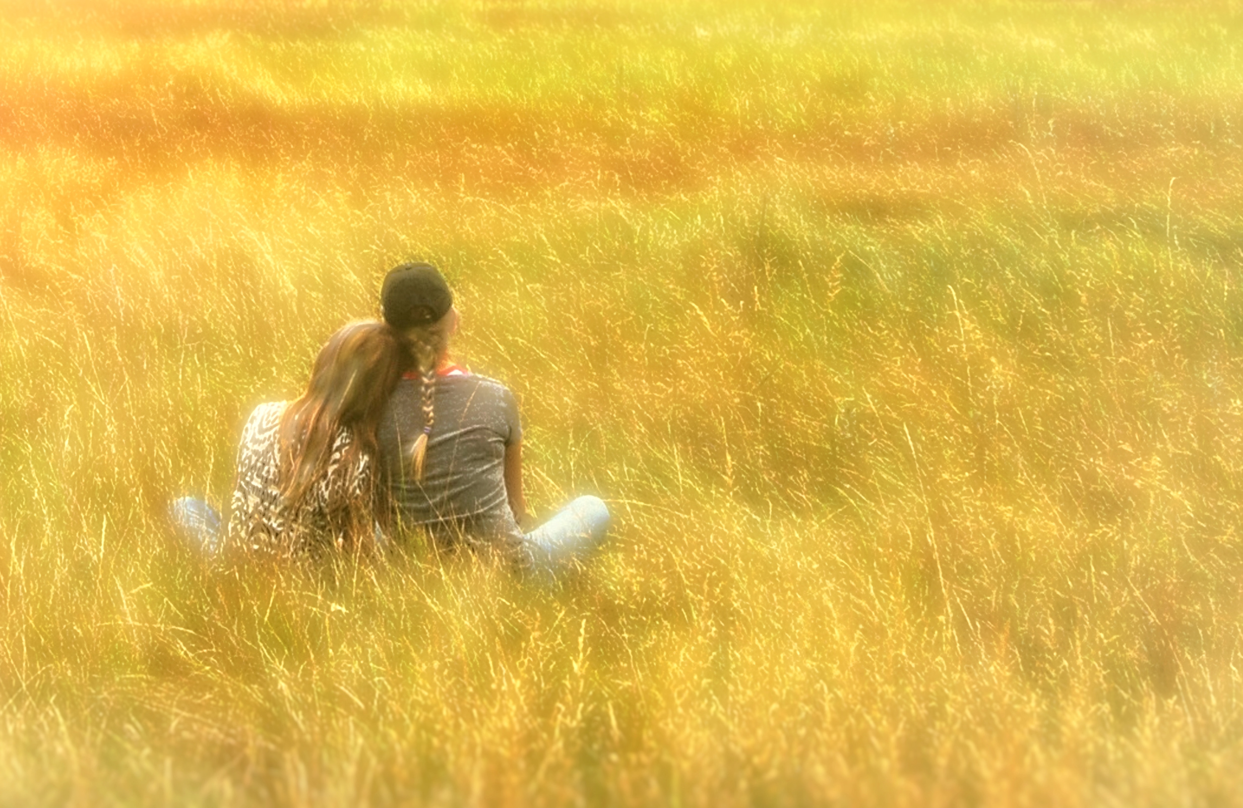 Hazy vintage looks - girls on the grass - with copyspace photo