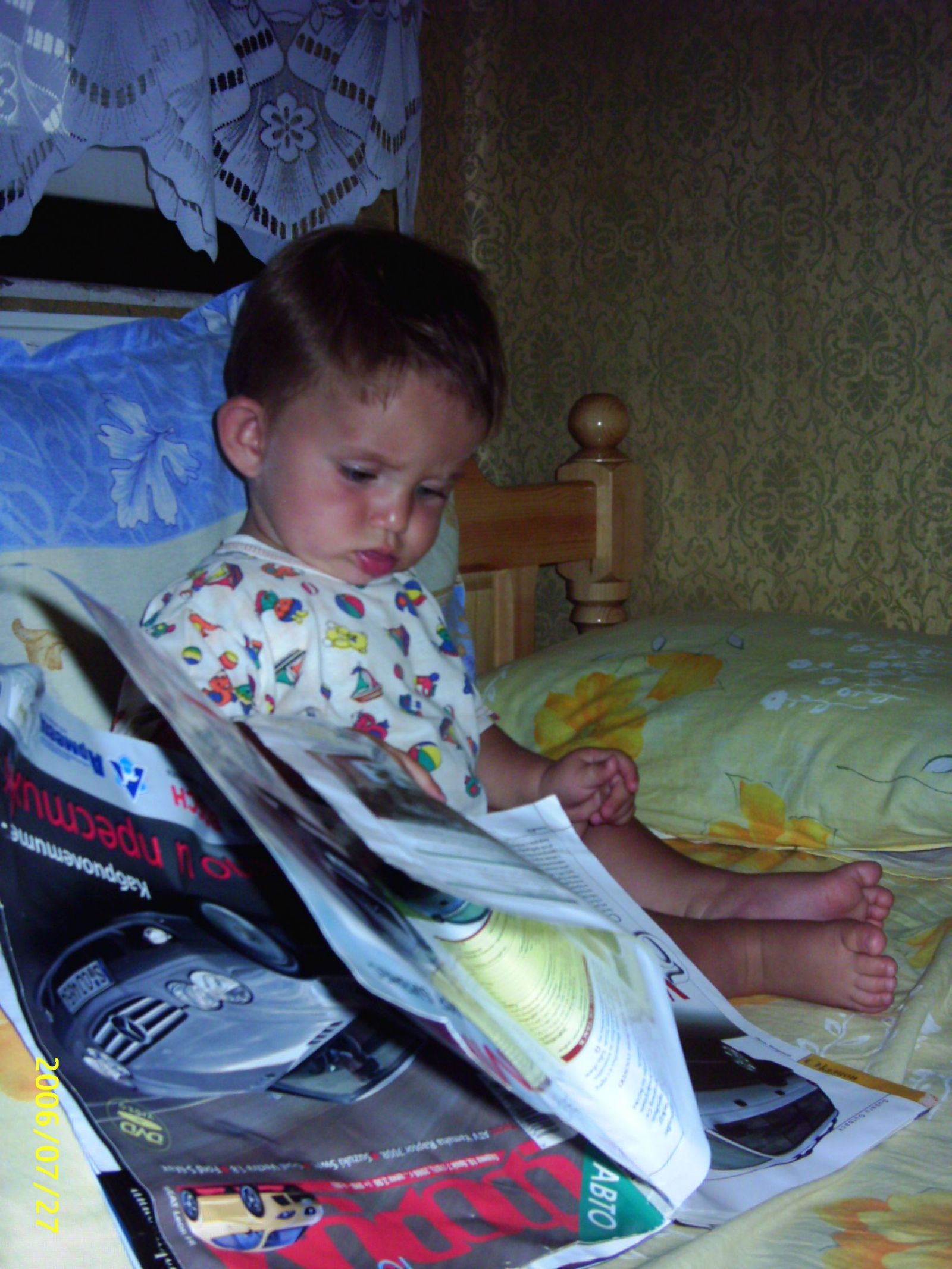 He is reading a magazine photo