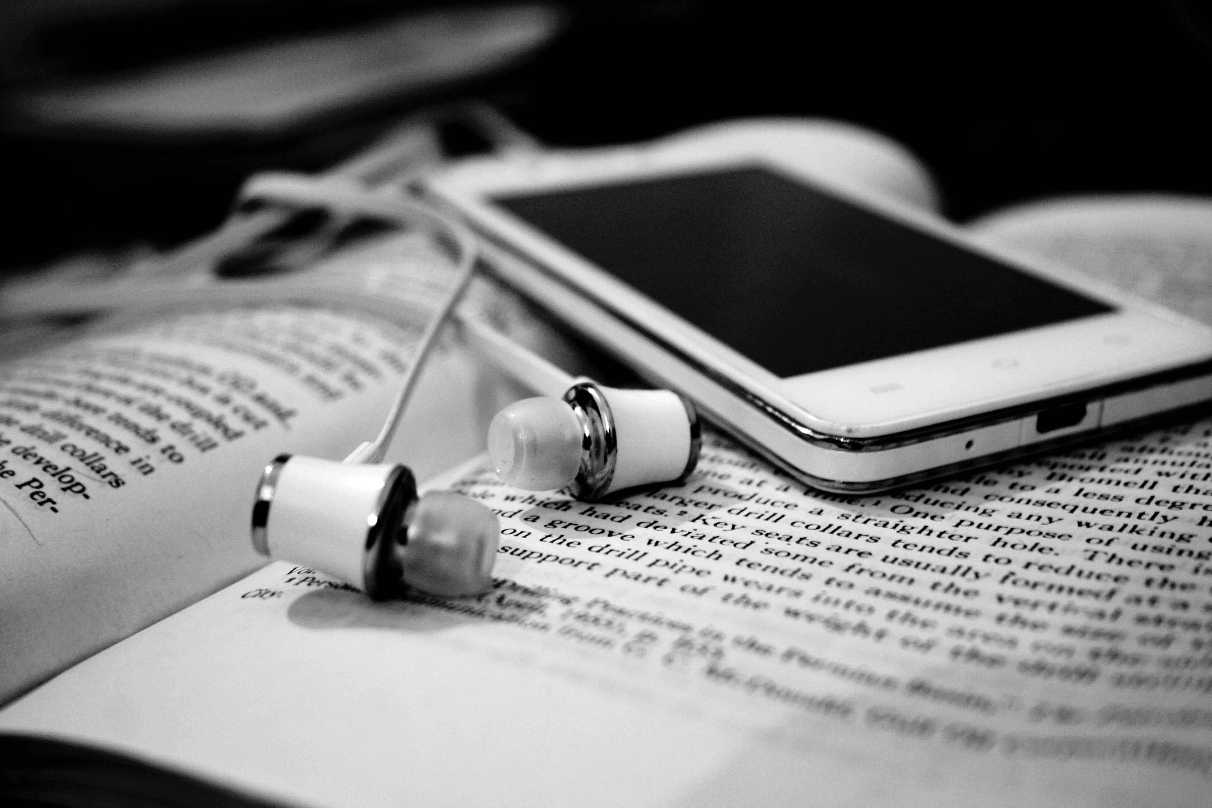 Free stock photo of black and white, books, earphones