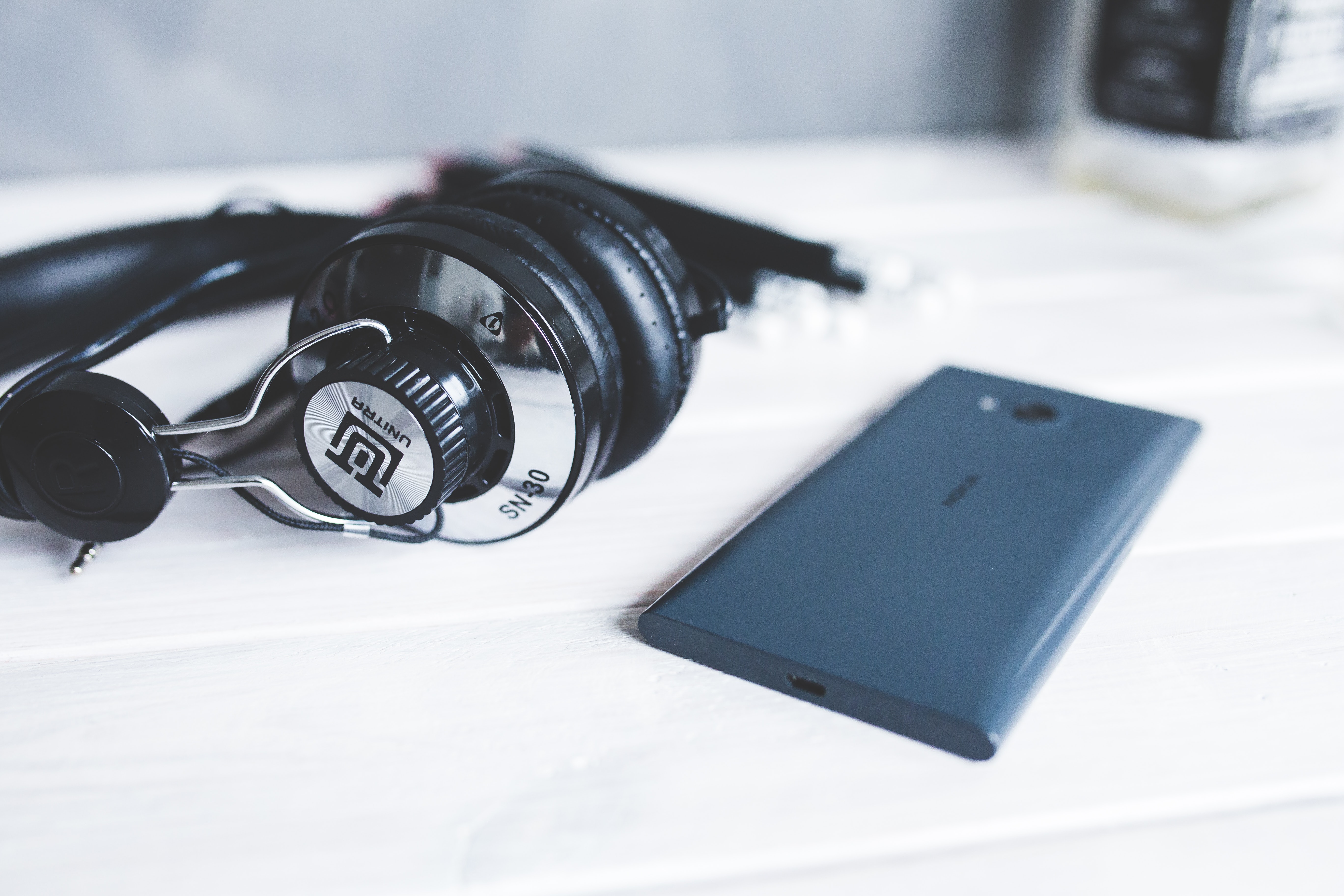 Closeup of headphones with smart phone II · Free Stock Photo