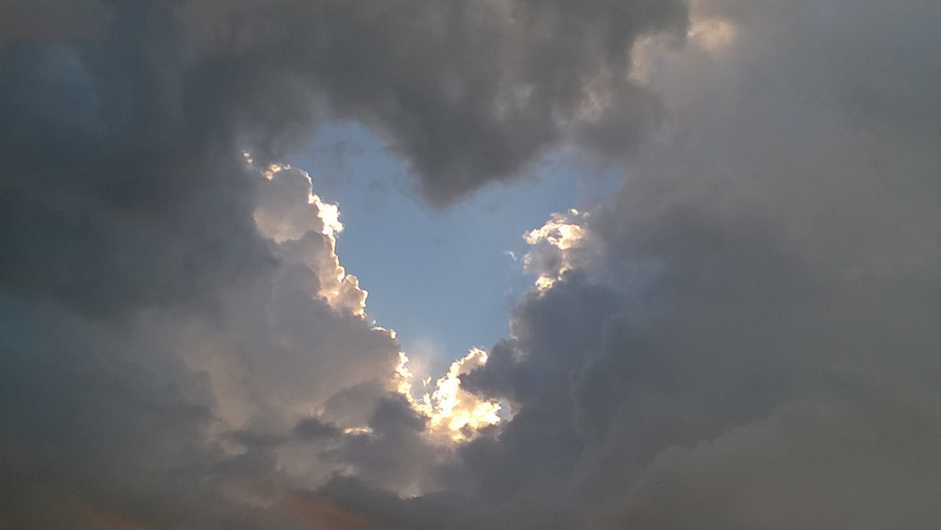 Heart shaped break in the clouds photo