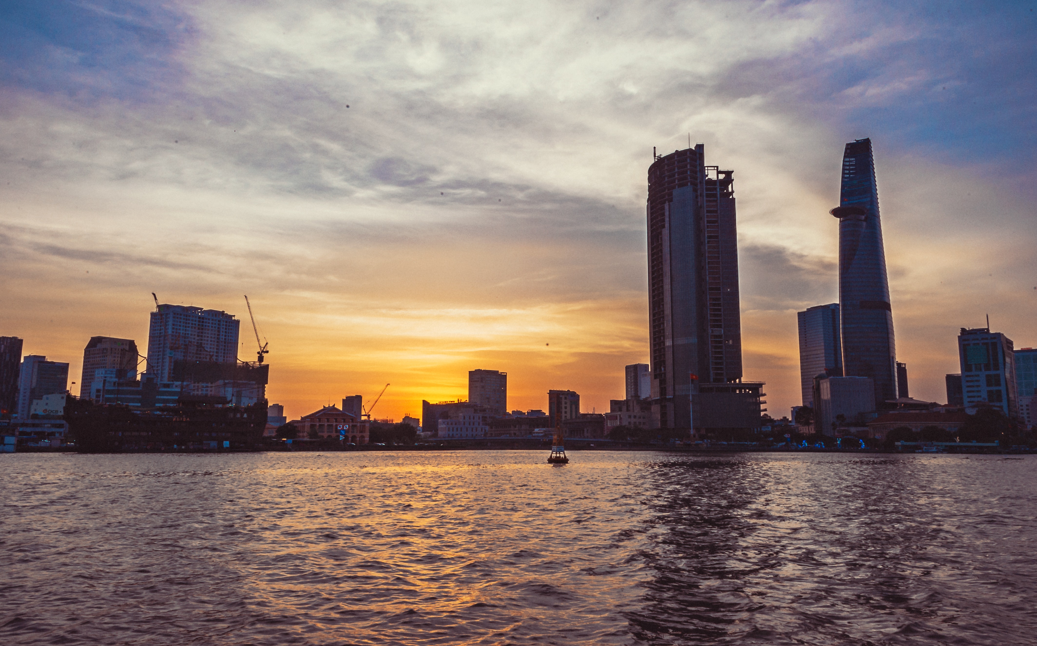 High-rise building in front of body of water during sunset photo
