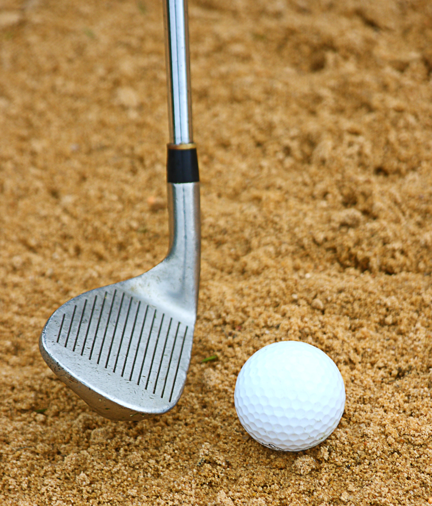 Hitting a golf ball out of a bunker photo
