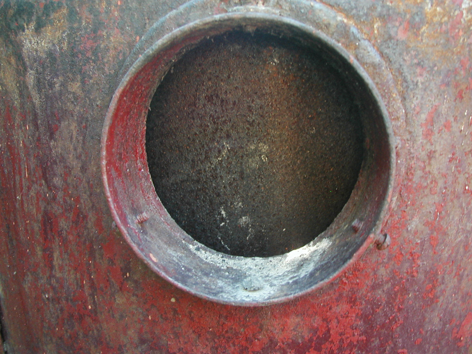 Hole in a rusted steel tank photo