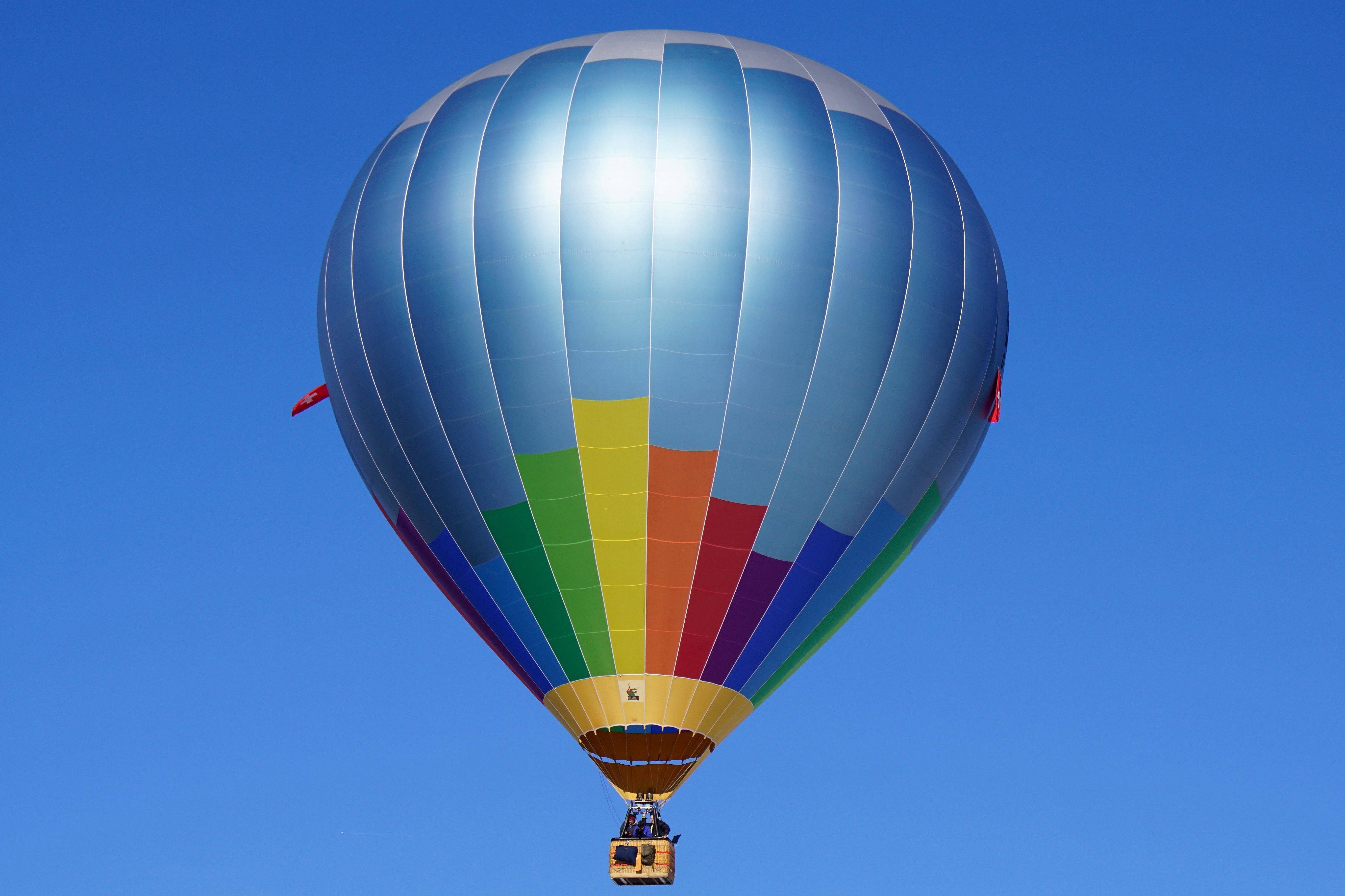 Hot air balloon flying against blue sky photo