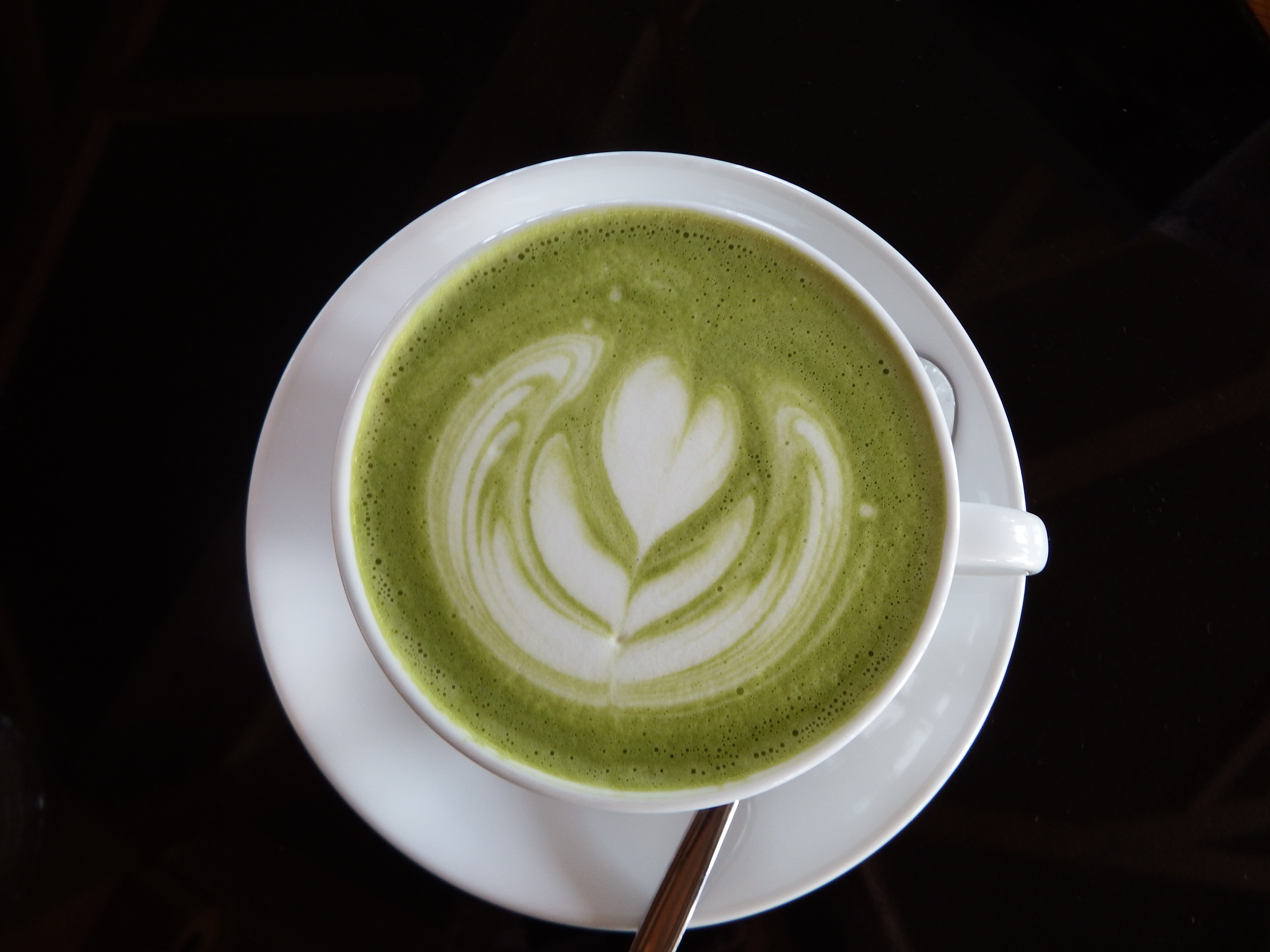 Hot green tea with heart art photo