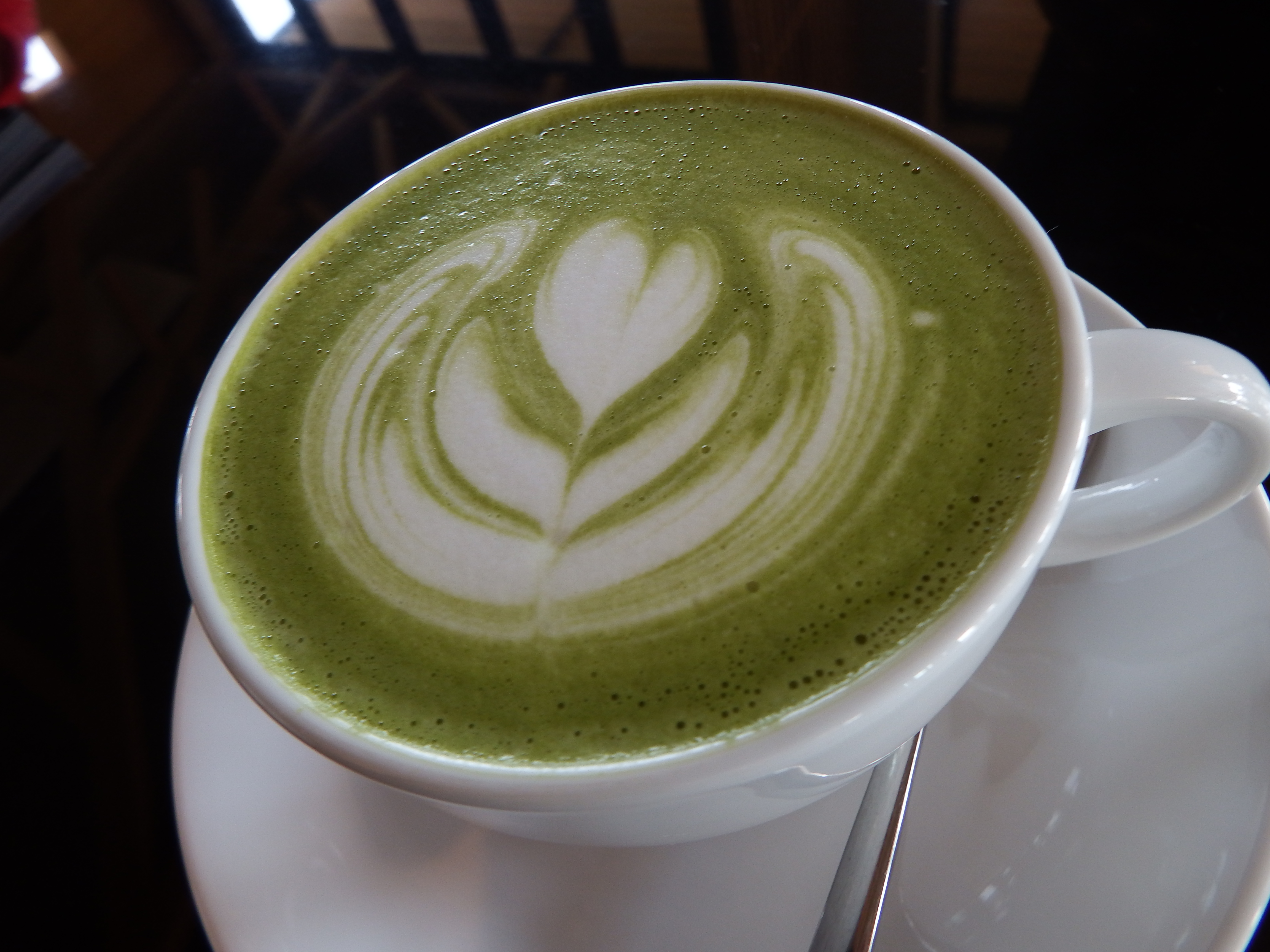 Hot green tea with heart art photo