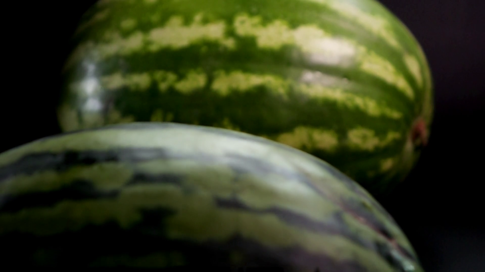 Slow motion: two fresh striped green huge big tasty watermelons at ...