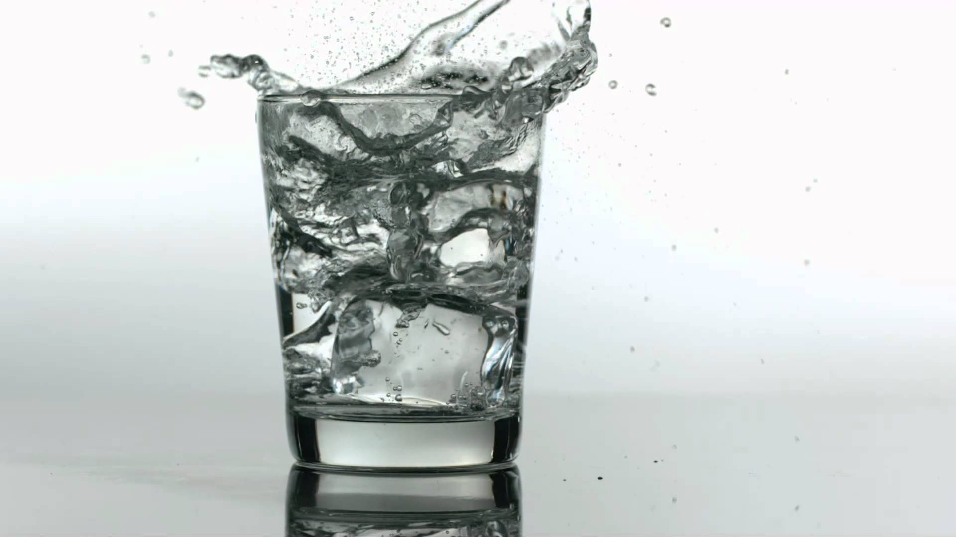 Slow Motion Ice Dropping into Water Glass - YouTube