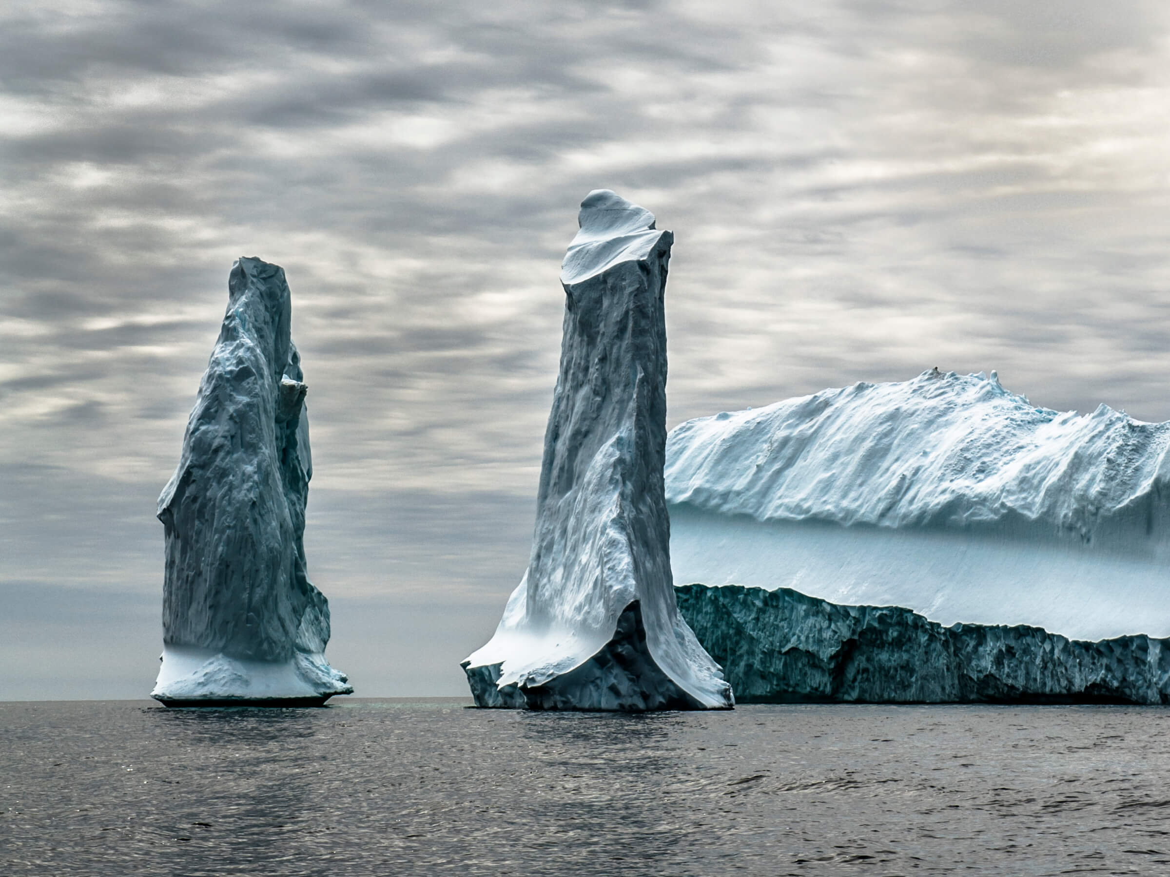 Pillars of ice in front of an iceberg in South Greenland, by Camilla ...