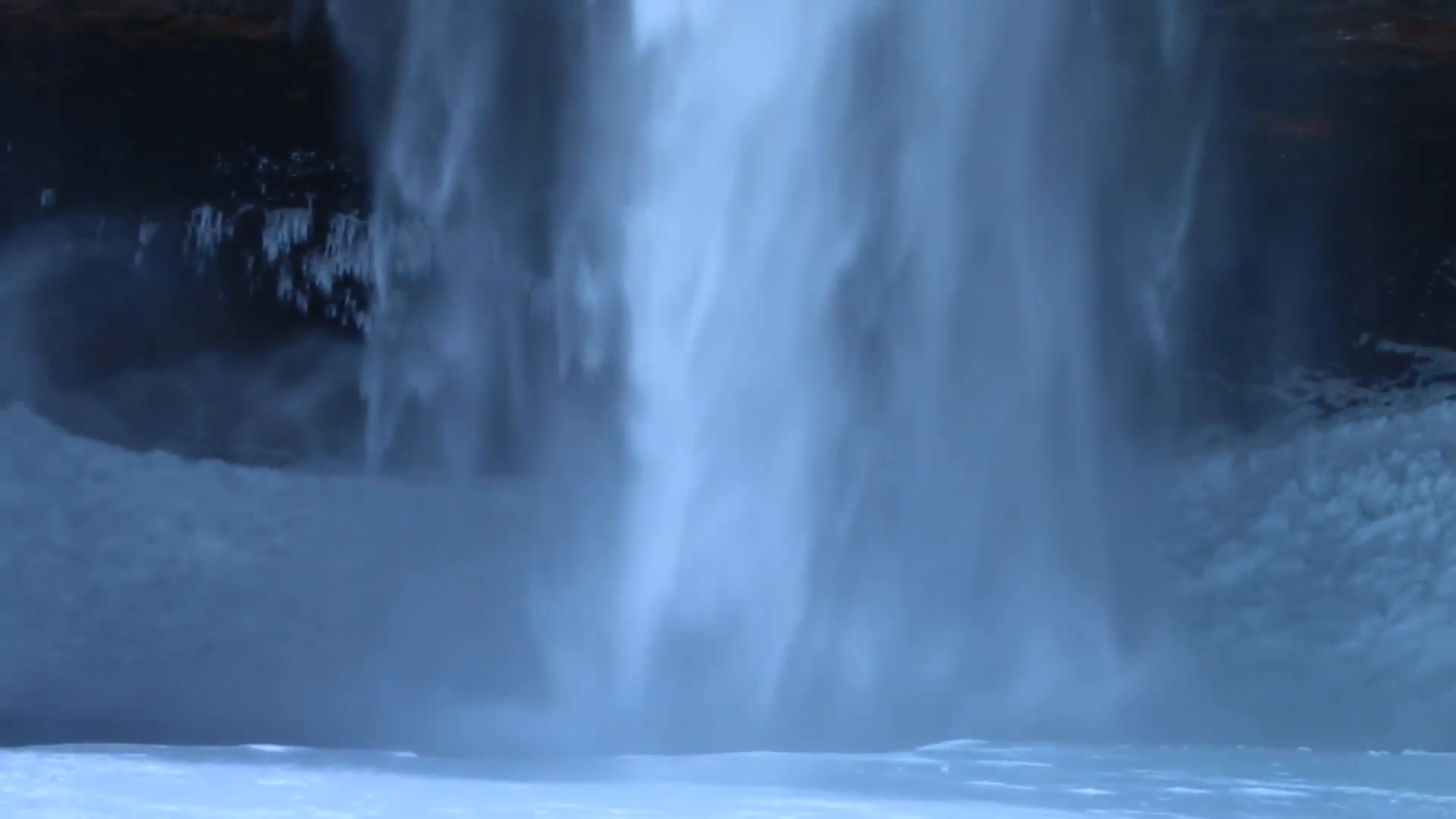 closeup of streaming waterfall hit on frozen, icy ground which bring ...