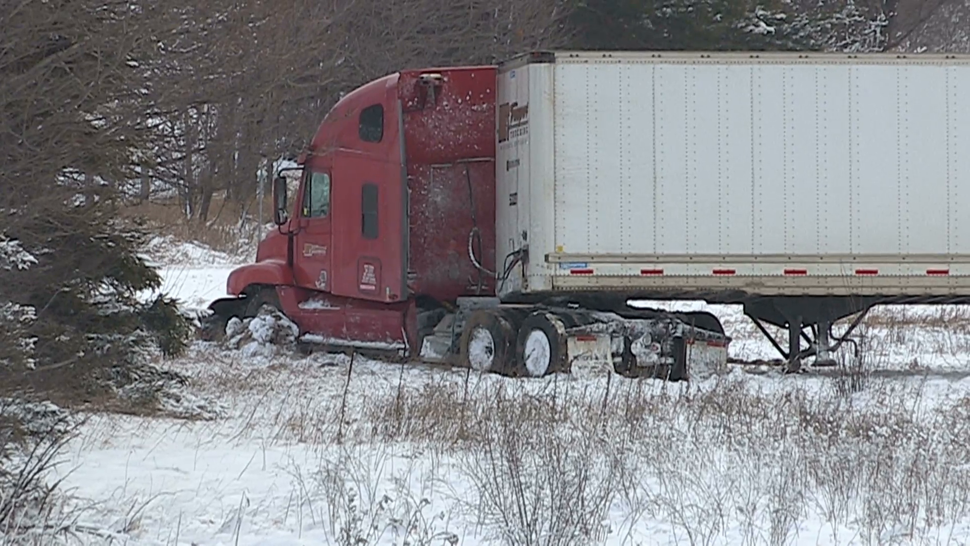 Tractor trailer truck crash and in ditch on icy road after blizzard ...