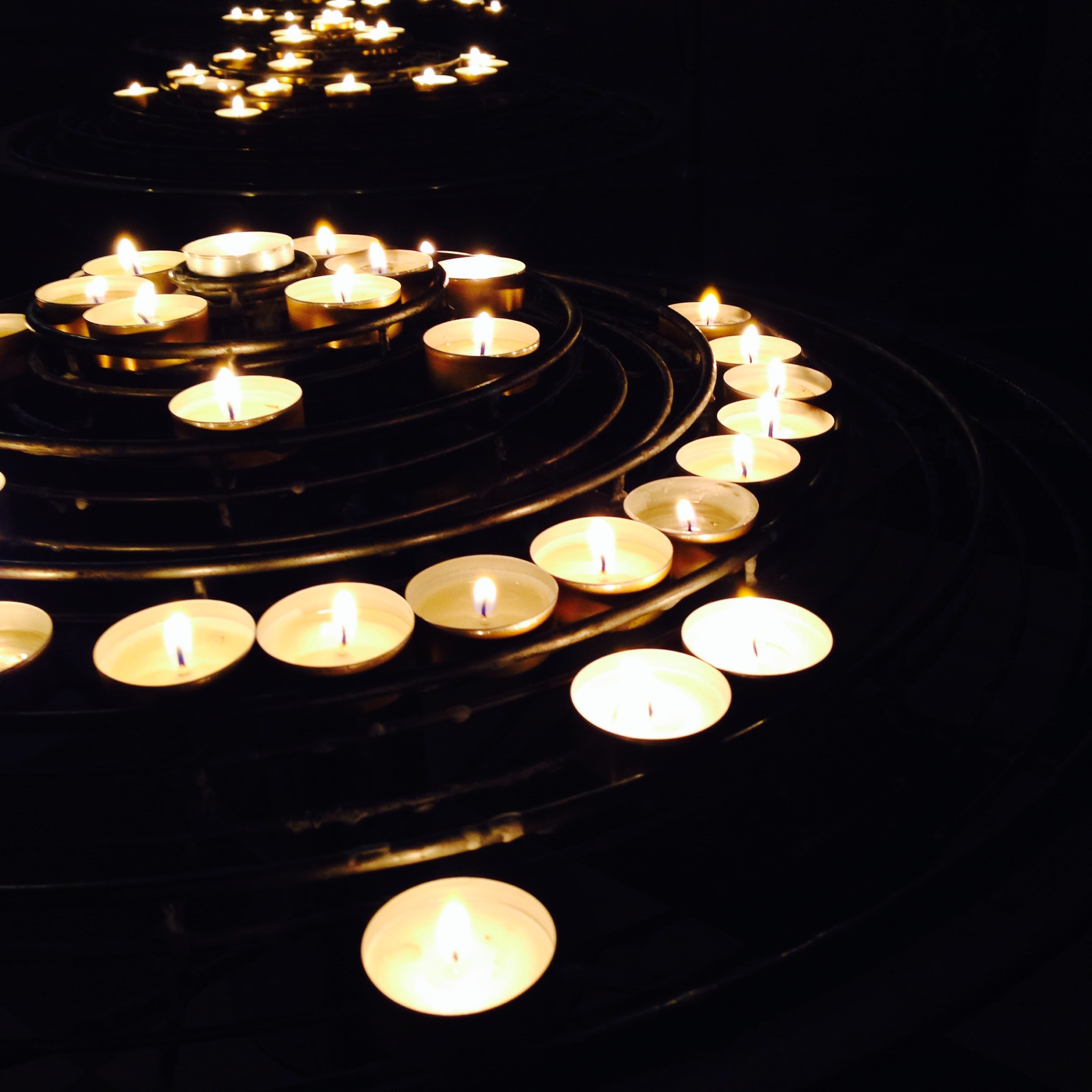Illuminated candles on black background photo