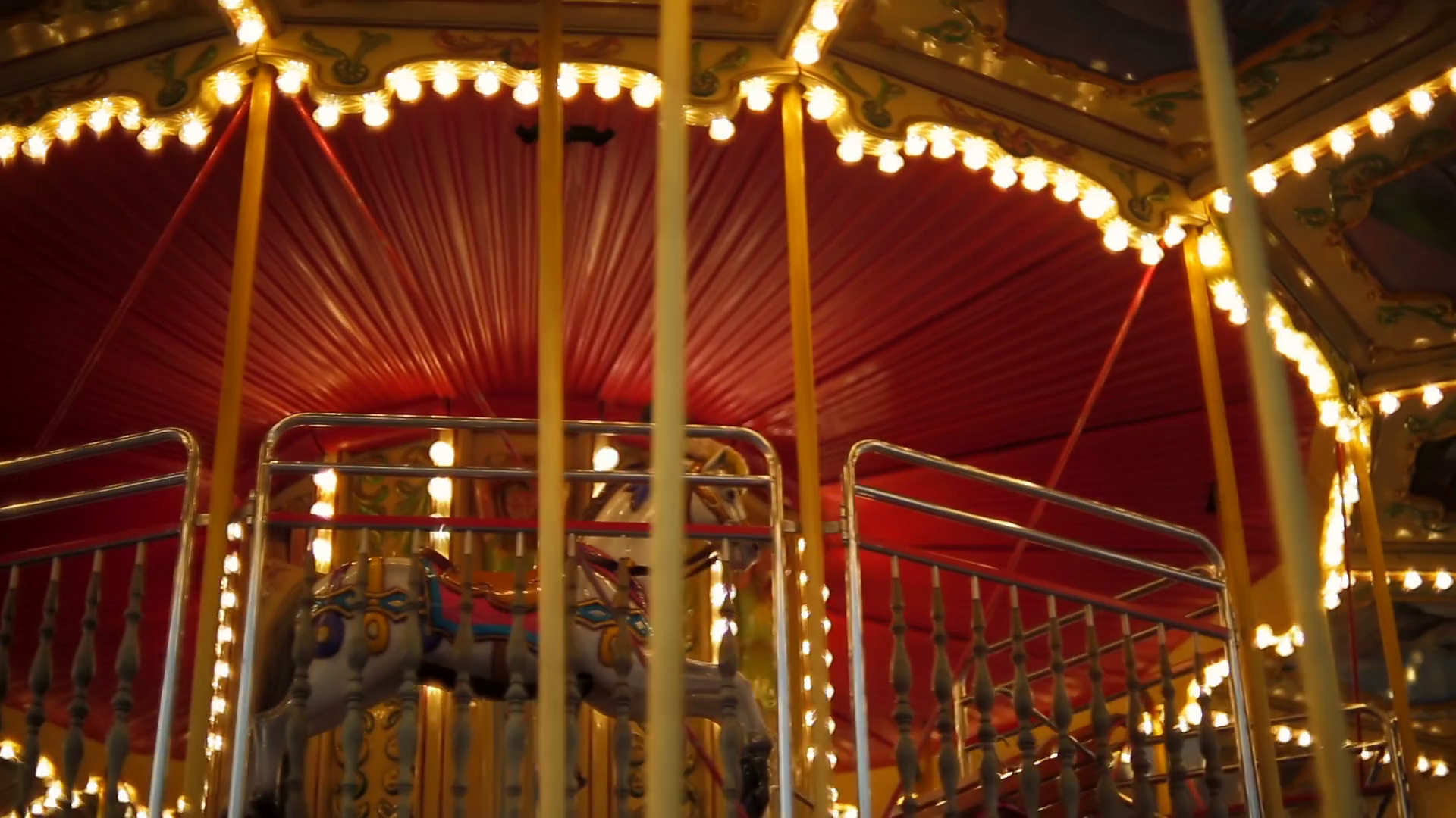 Illuminated merry-go-round carousel in amusement park at night Stock ...